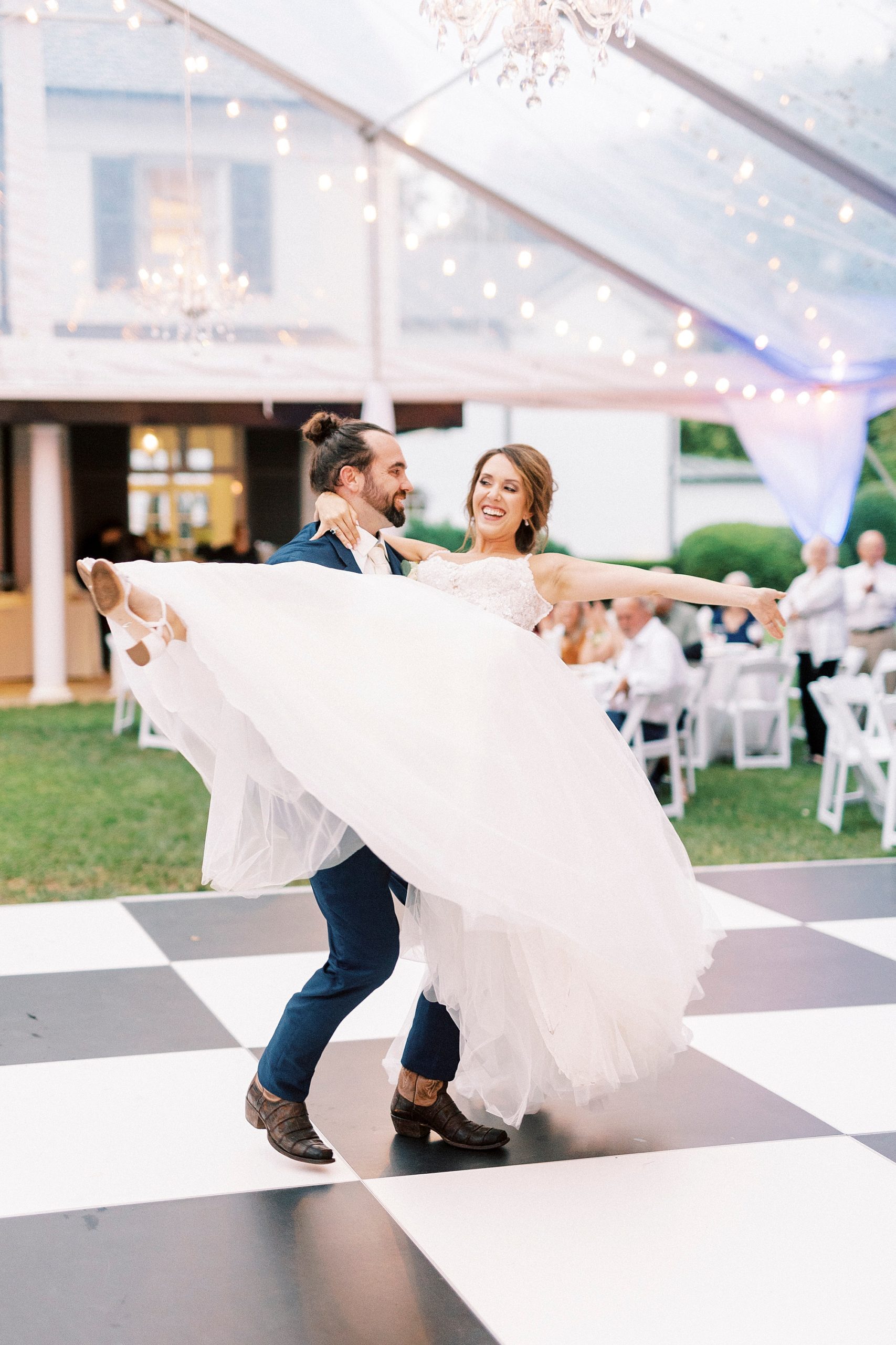 groom twirls bride around during first dance