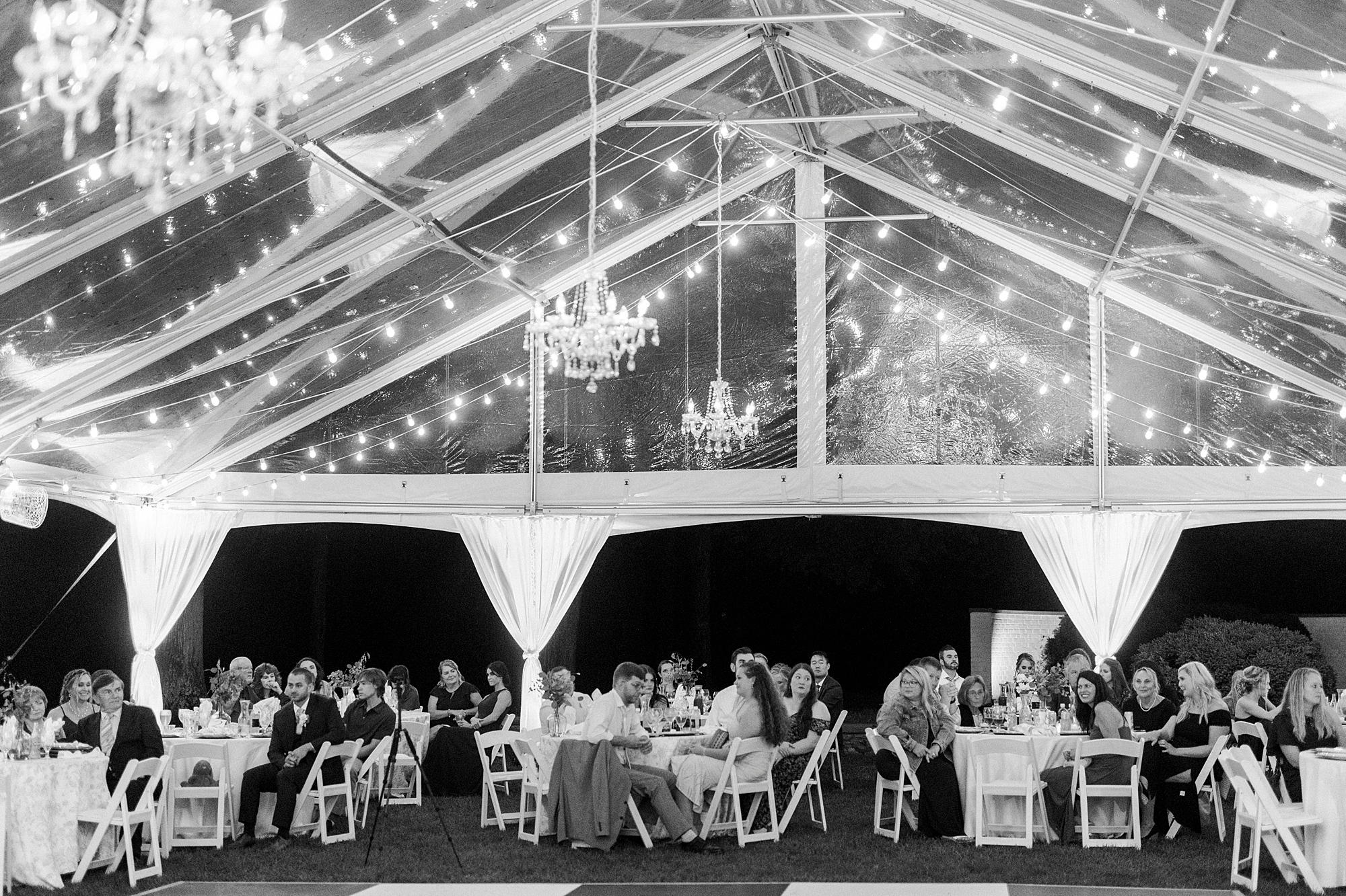 tented wedding reception with chandeliers hanging at Boxwood Estate
