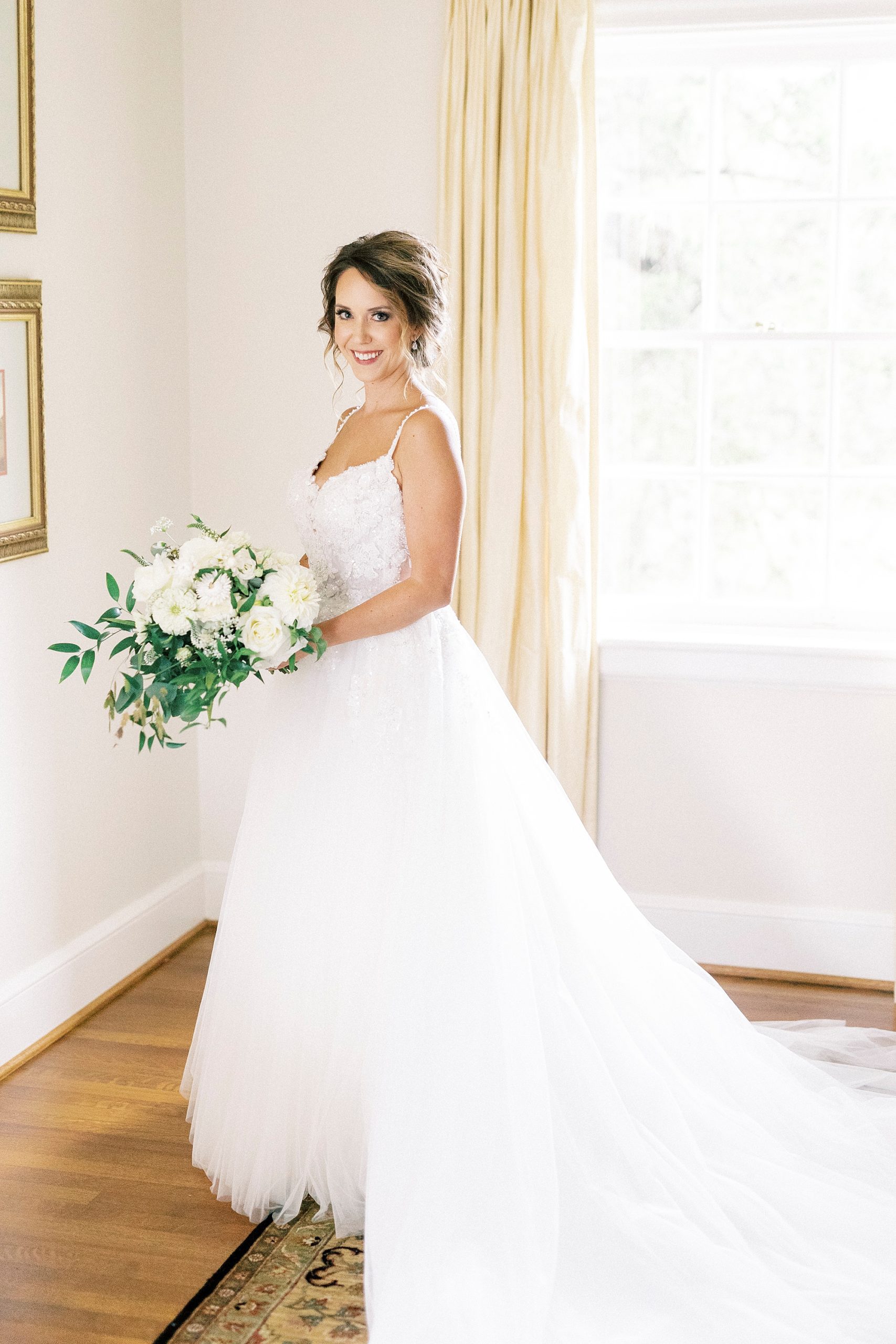 bridal portrait of bride holding white bouquet in suite at Boxwood Estate