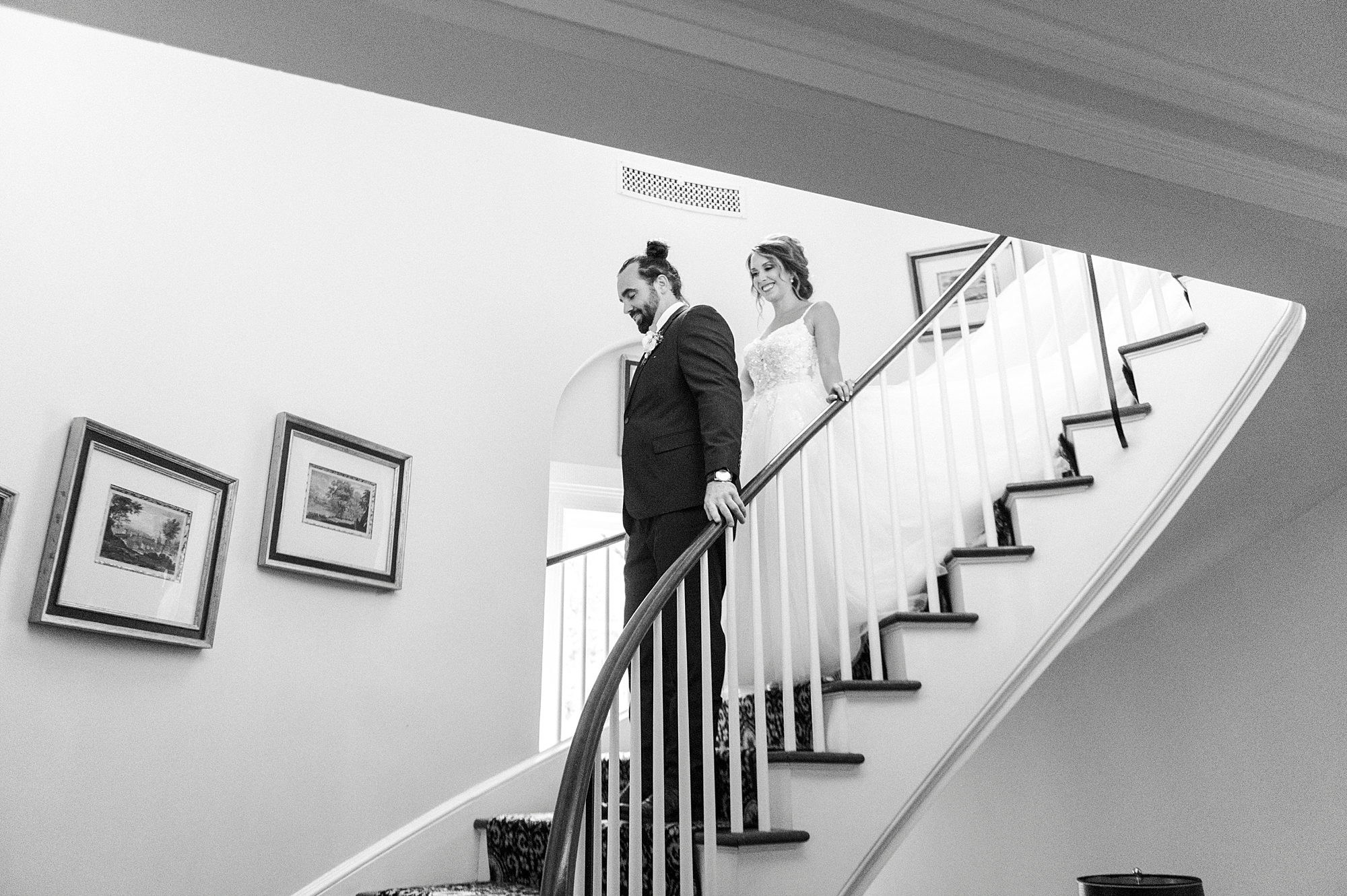 bride walks down steps to meet groom for first touch at Boxwood Estate