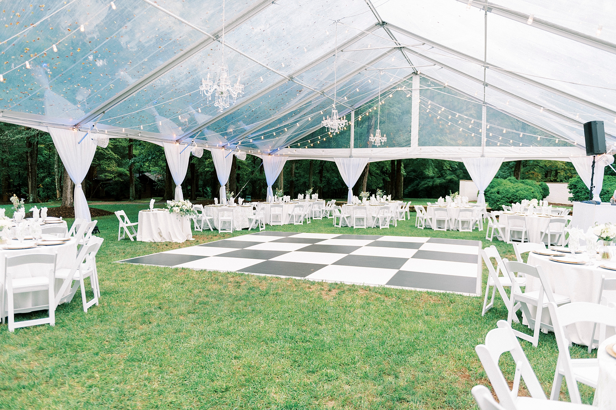 tented wedding reception with black and white checked dance floor at Boxwood Estate