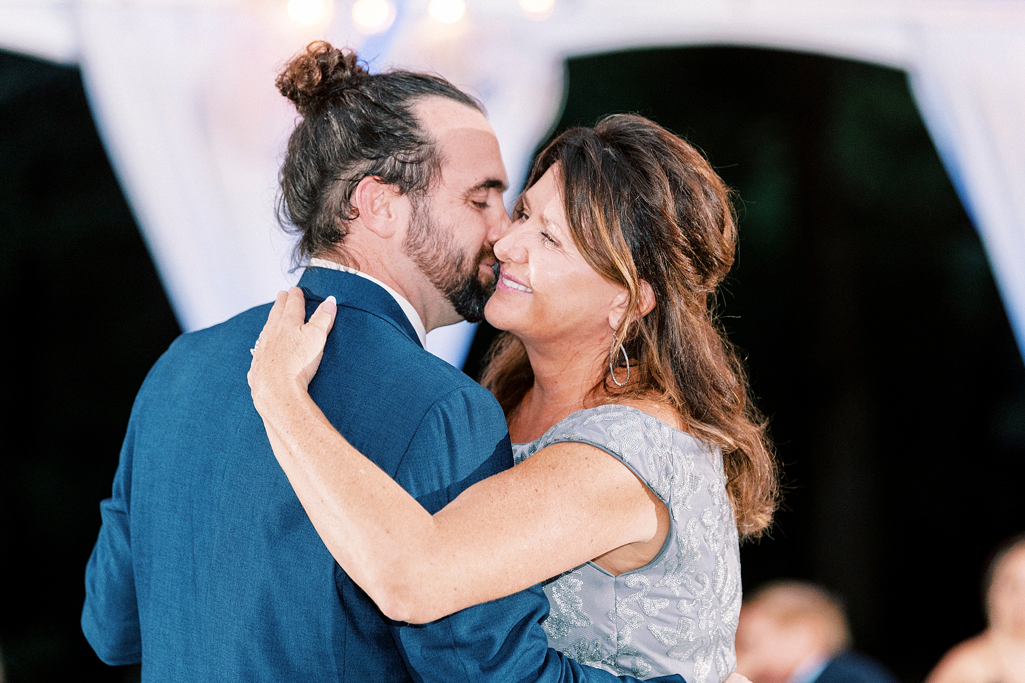 groom kisses mom on cheek during dance at reception