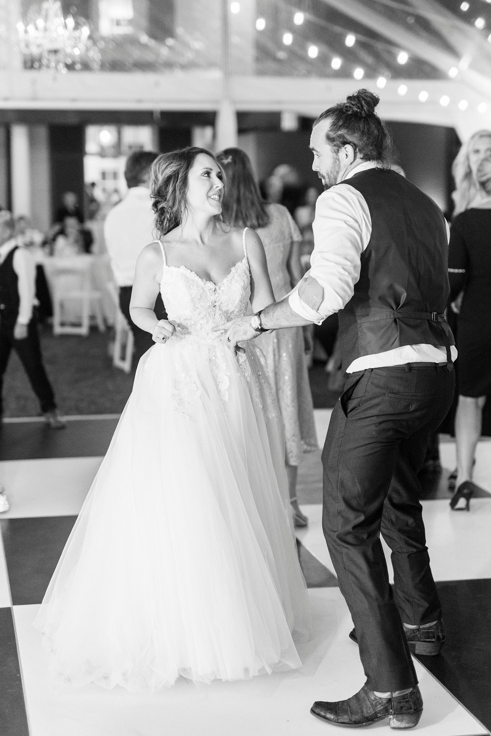newlyweds dance on checked floor at Boxwood Estate