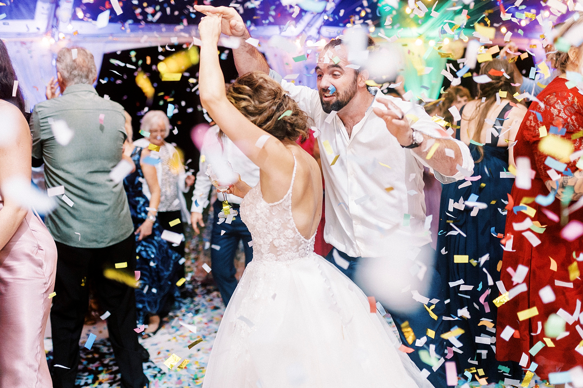 bride and groom dance during Mocksville NC wedding reception while confetti falls