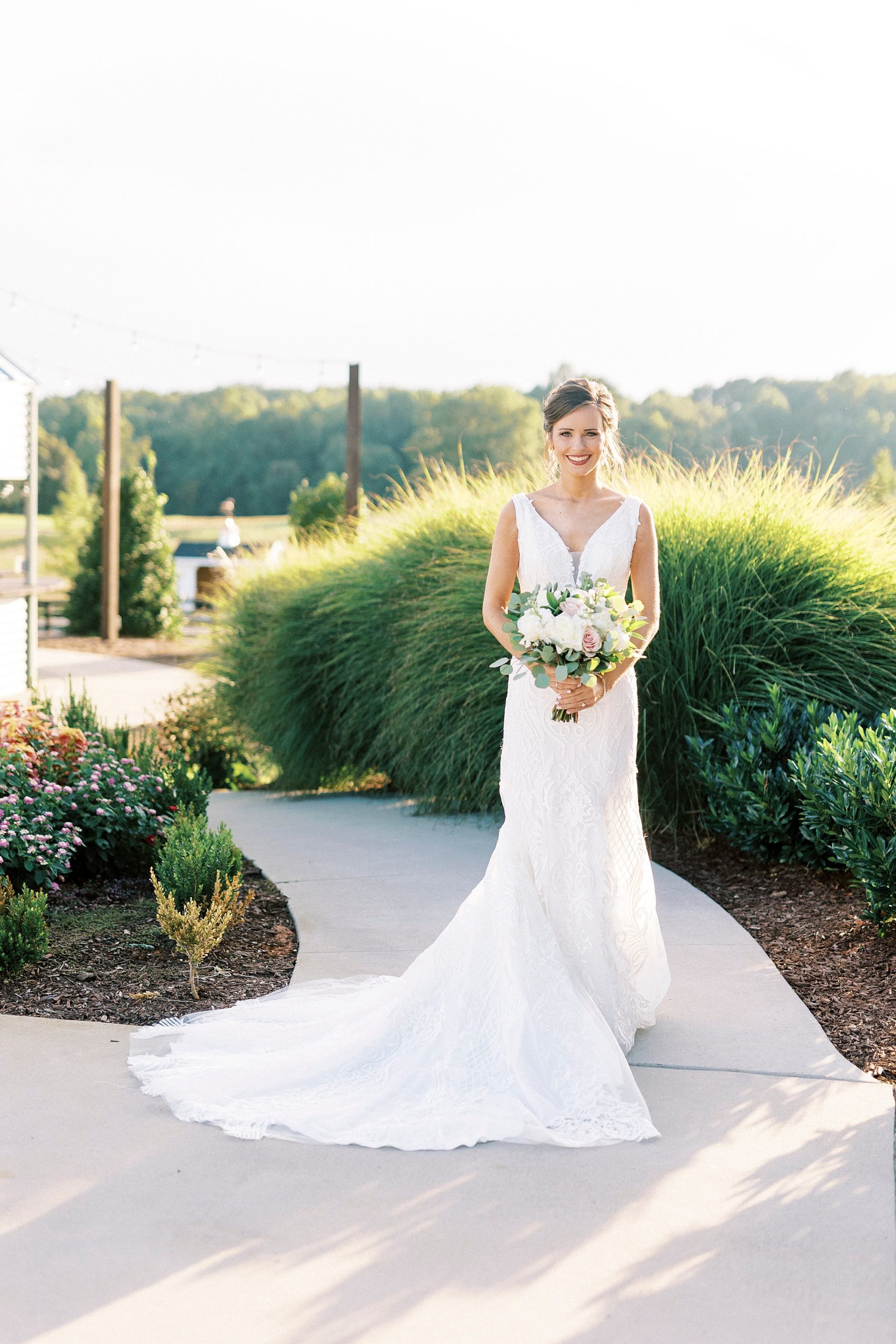 bride stands with dress skirt draped around her