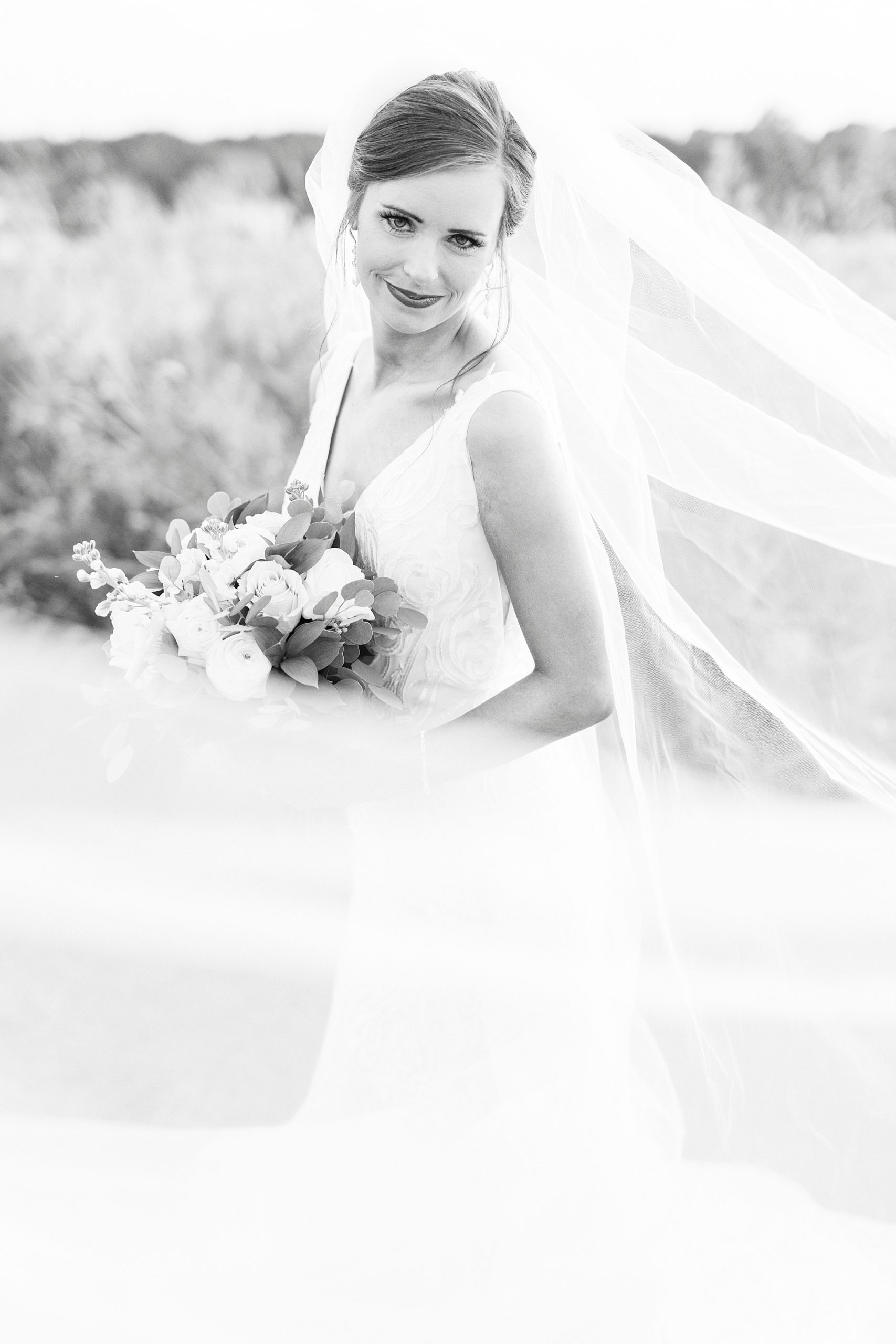 black and white portrait of bride with veil around her at Chickadee Hill Farms