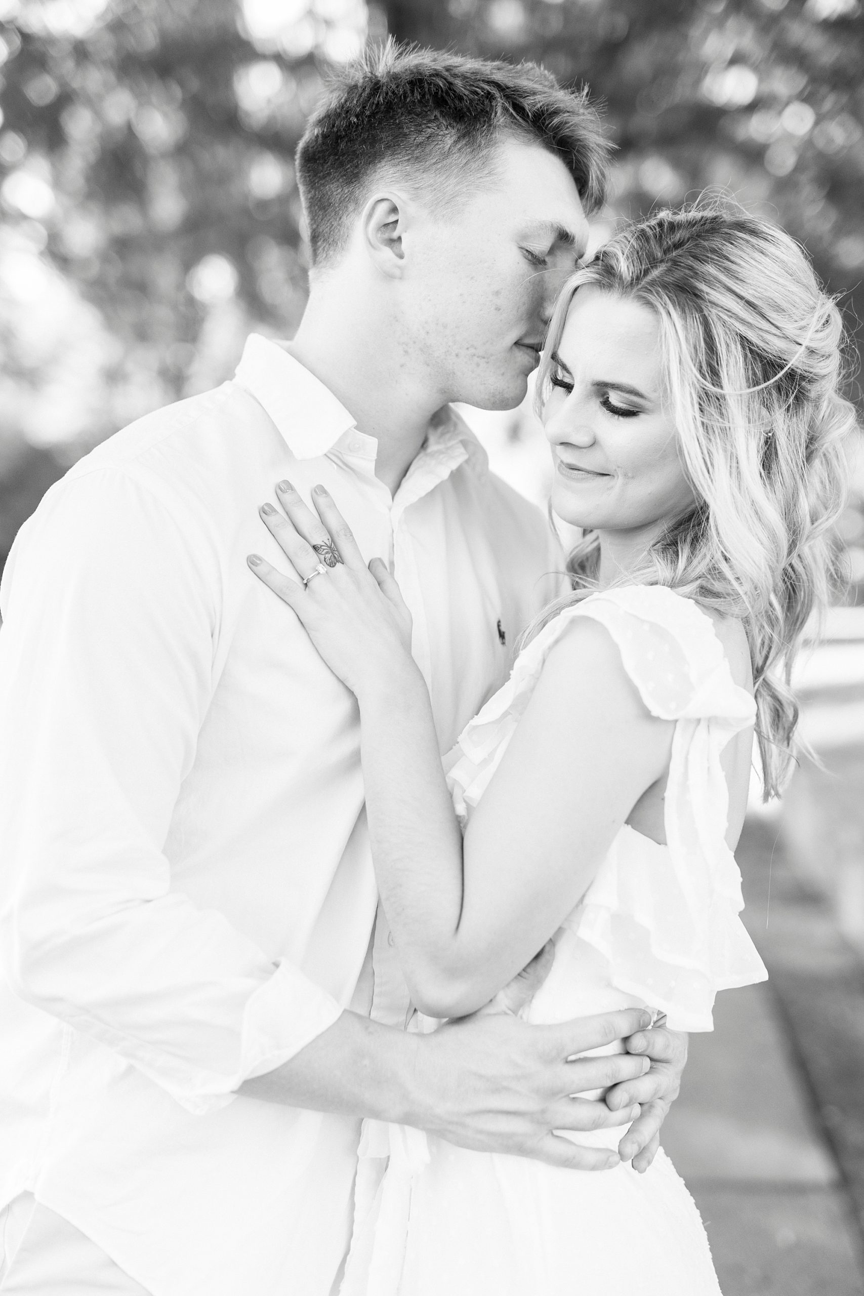 groom nuzzles bride's forehead during Downtown Concord engagement portraits