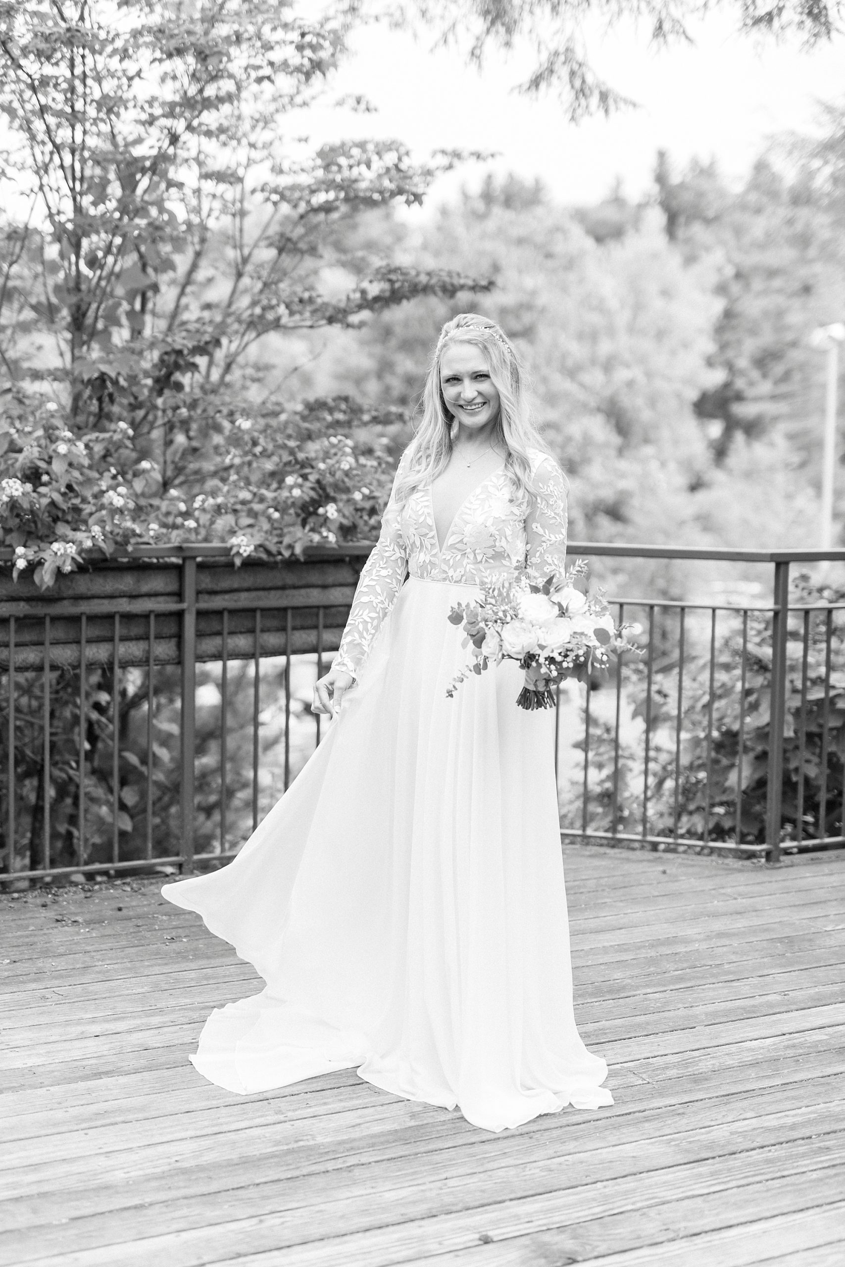 bride twirls in wedding gown on balcony at Chetola Resort