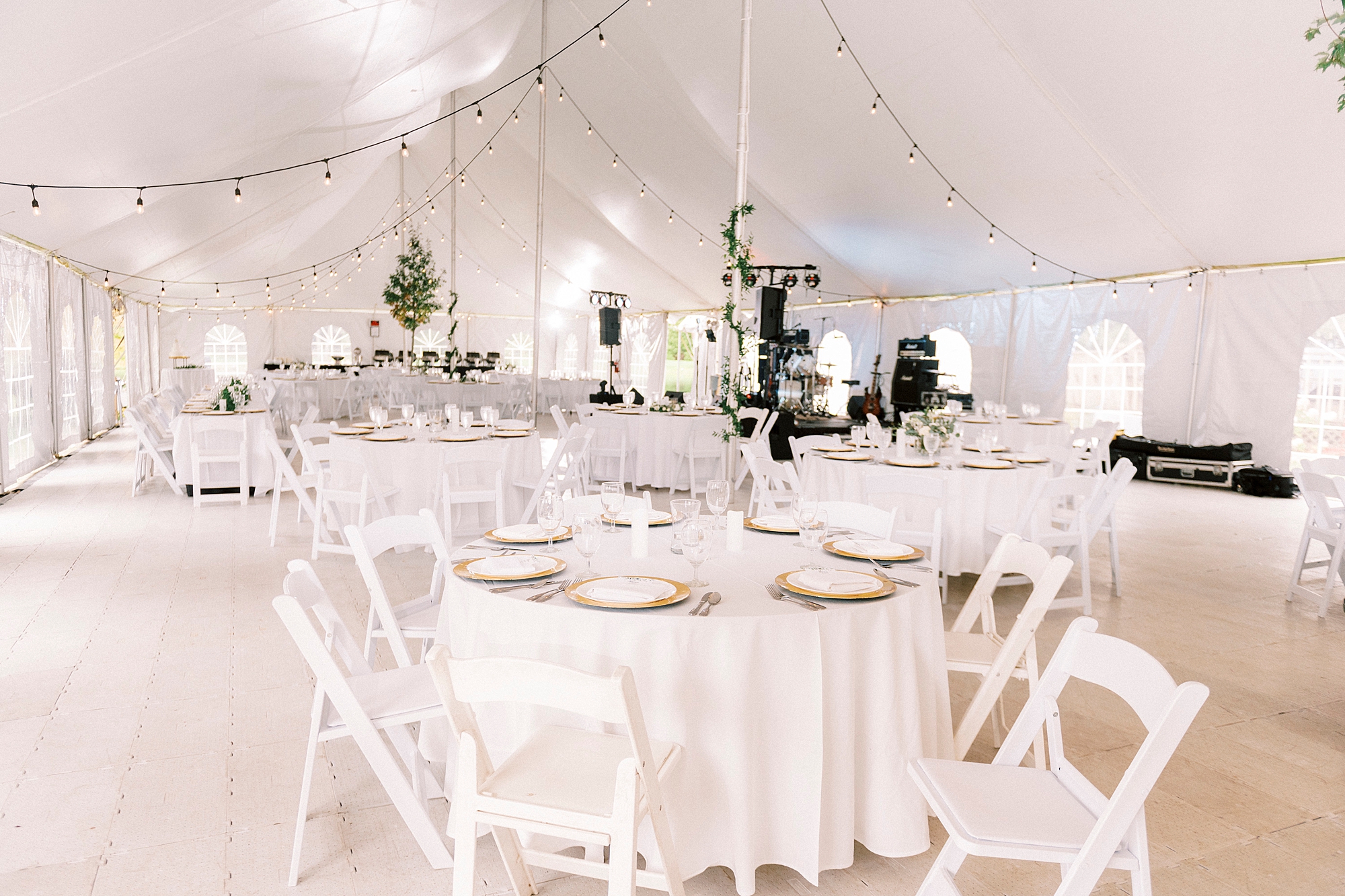 wedding reception with gold and white details under tent at Chetola Resort