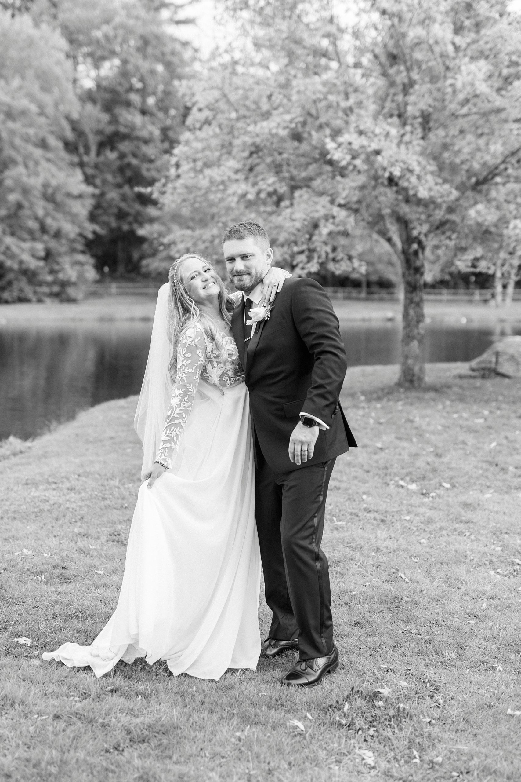 bride and groom smile laughing together during wedding photos 