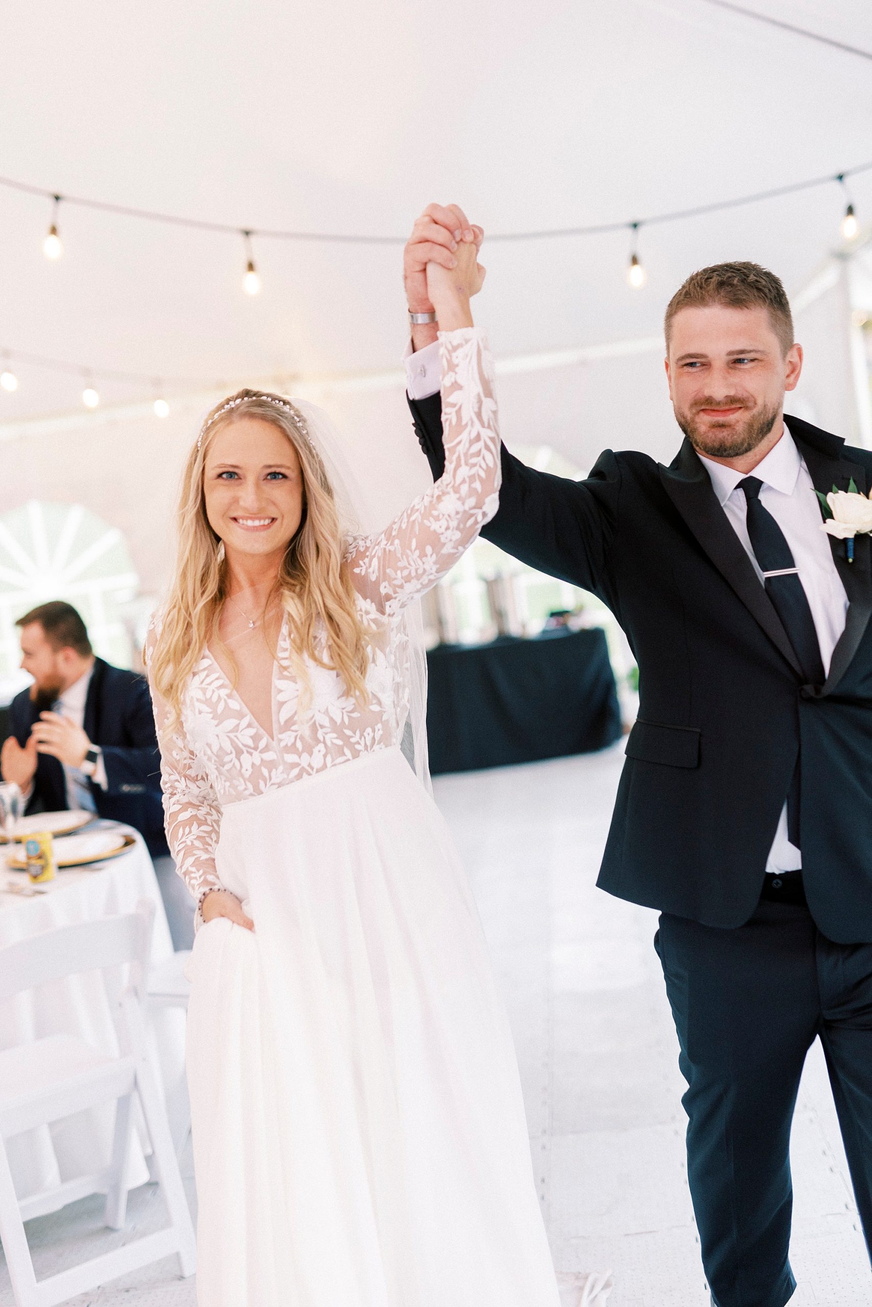 newlyweds cheer walking into wedding reception 