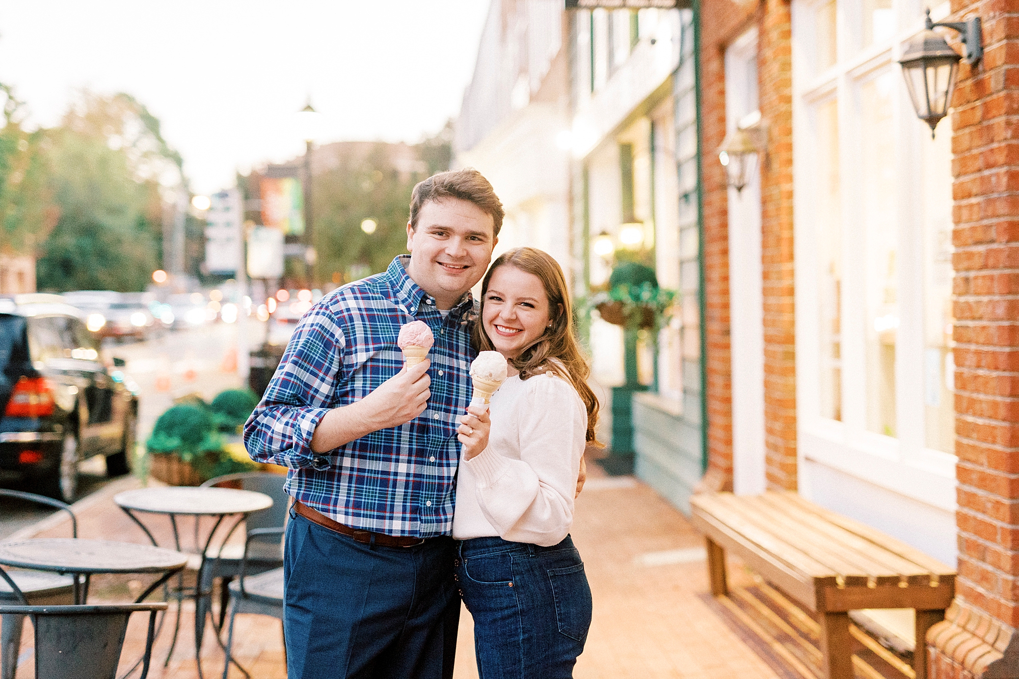 engaged couple hugs with ice cream outside Downtown Davidson shop 
