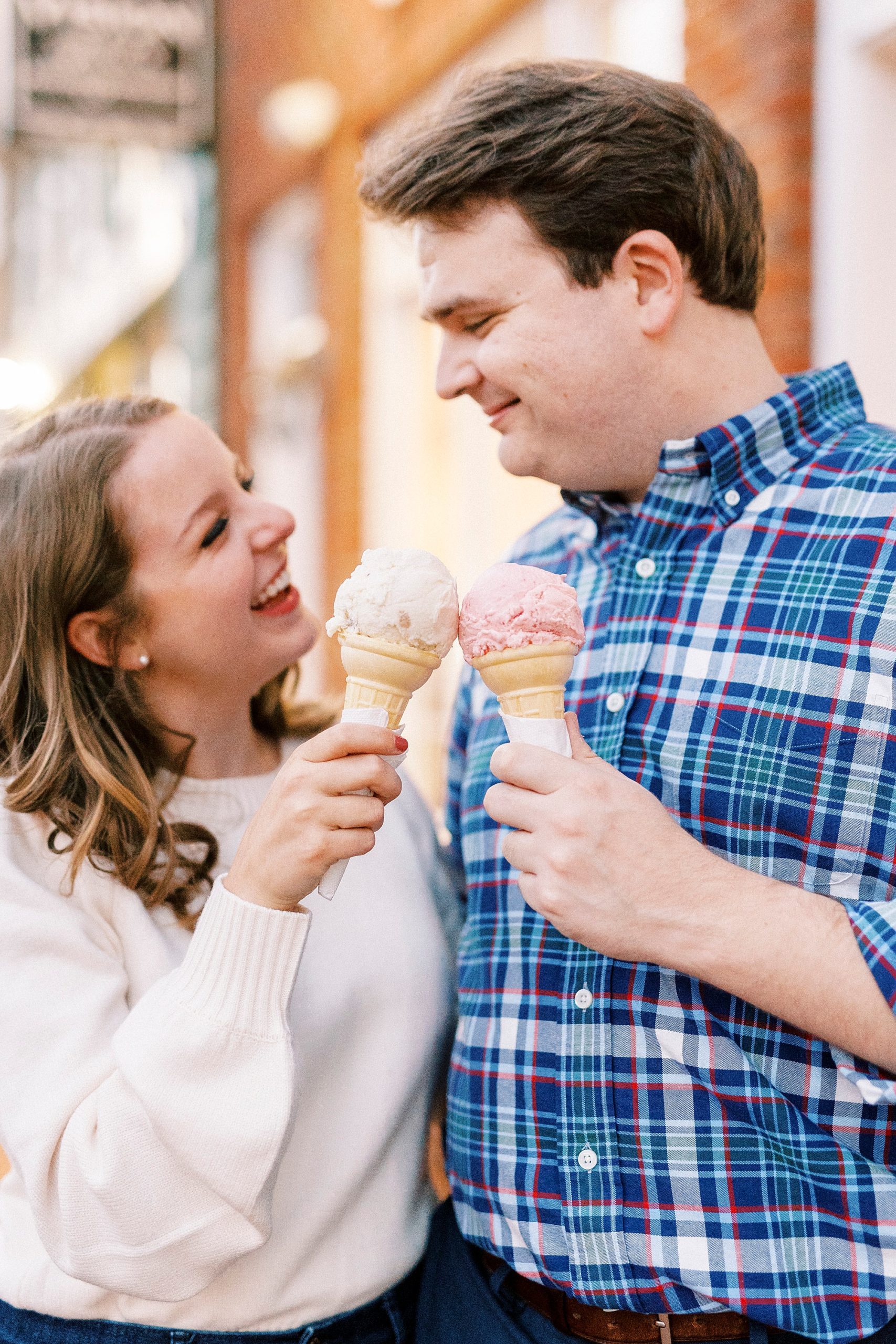 engaged couple holds ice cream together outside Downtown Davidson shop 