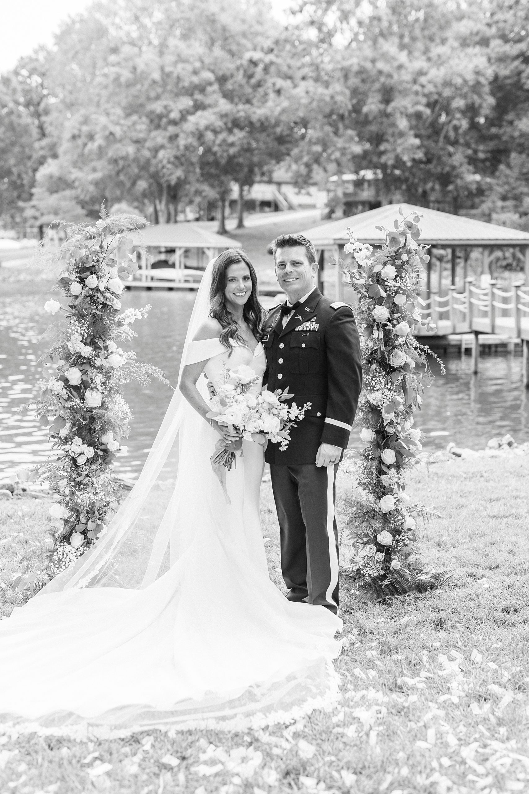 black and white portrait of newlyweds with floral arbor for Lake Norman wedding