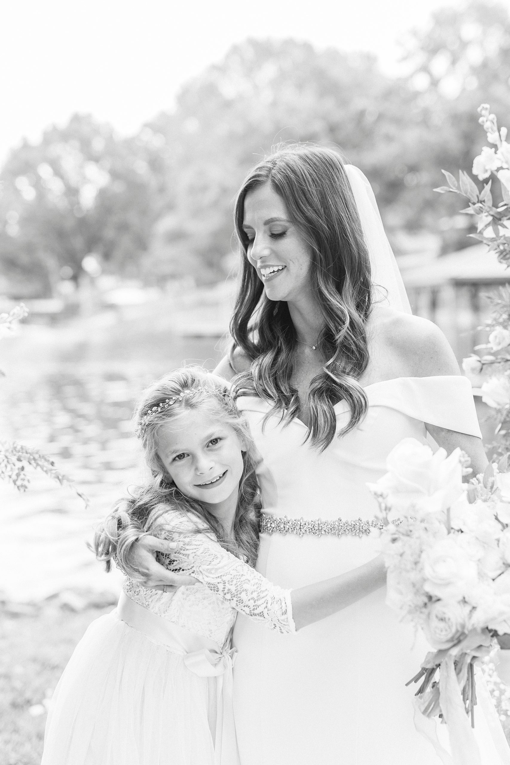 bride hugs stepdaughter during wedding portraits 