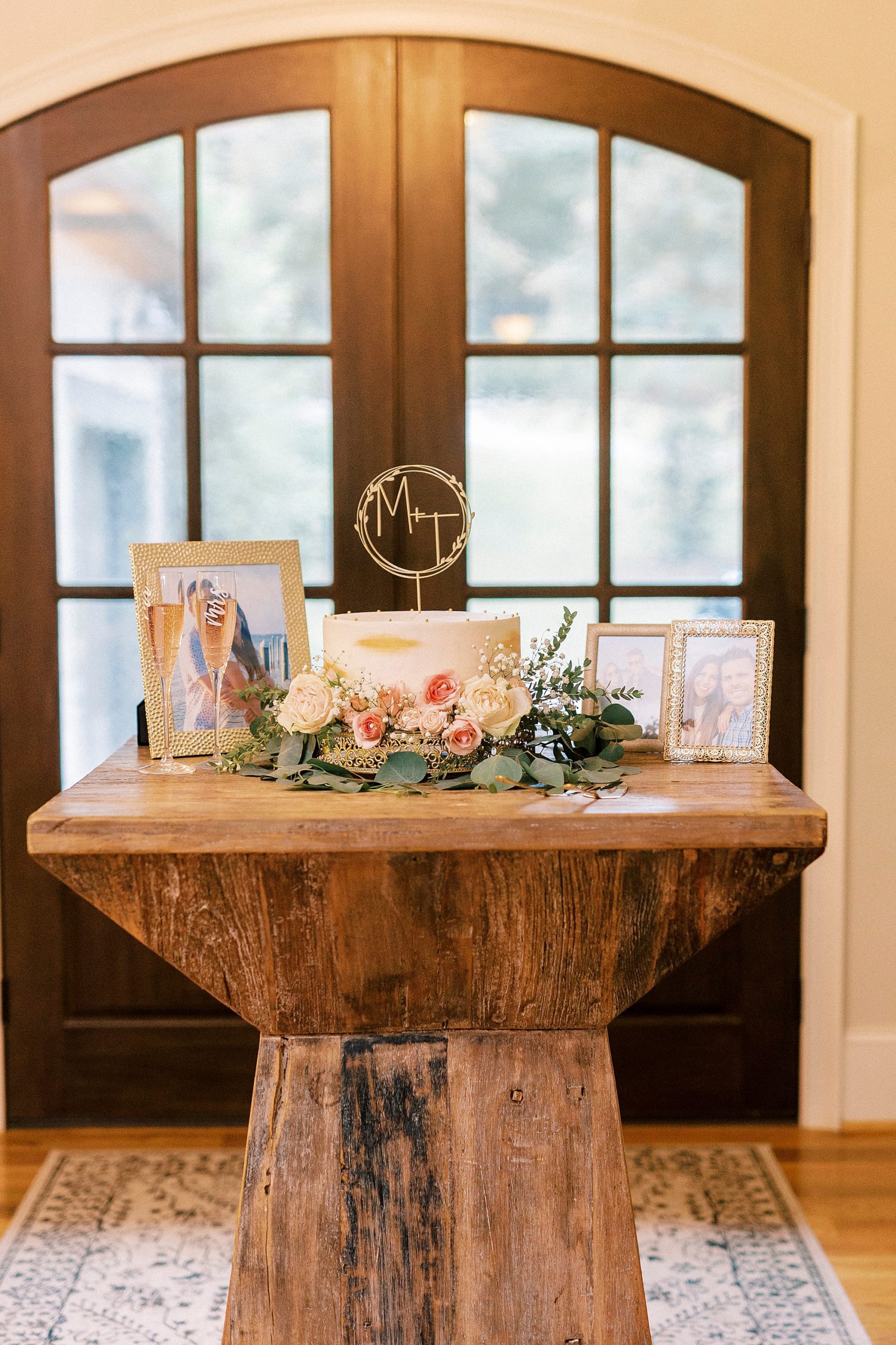 wedding cake stands on wooden table in Lake Norman home