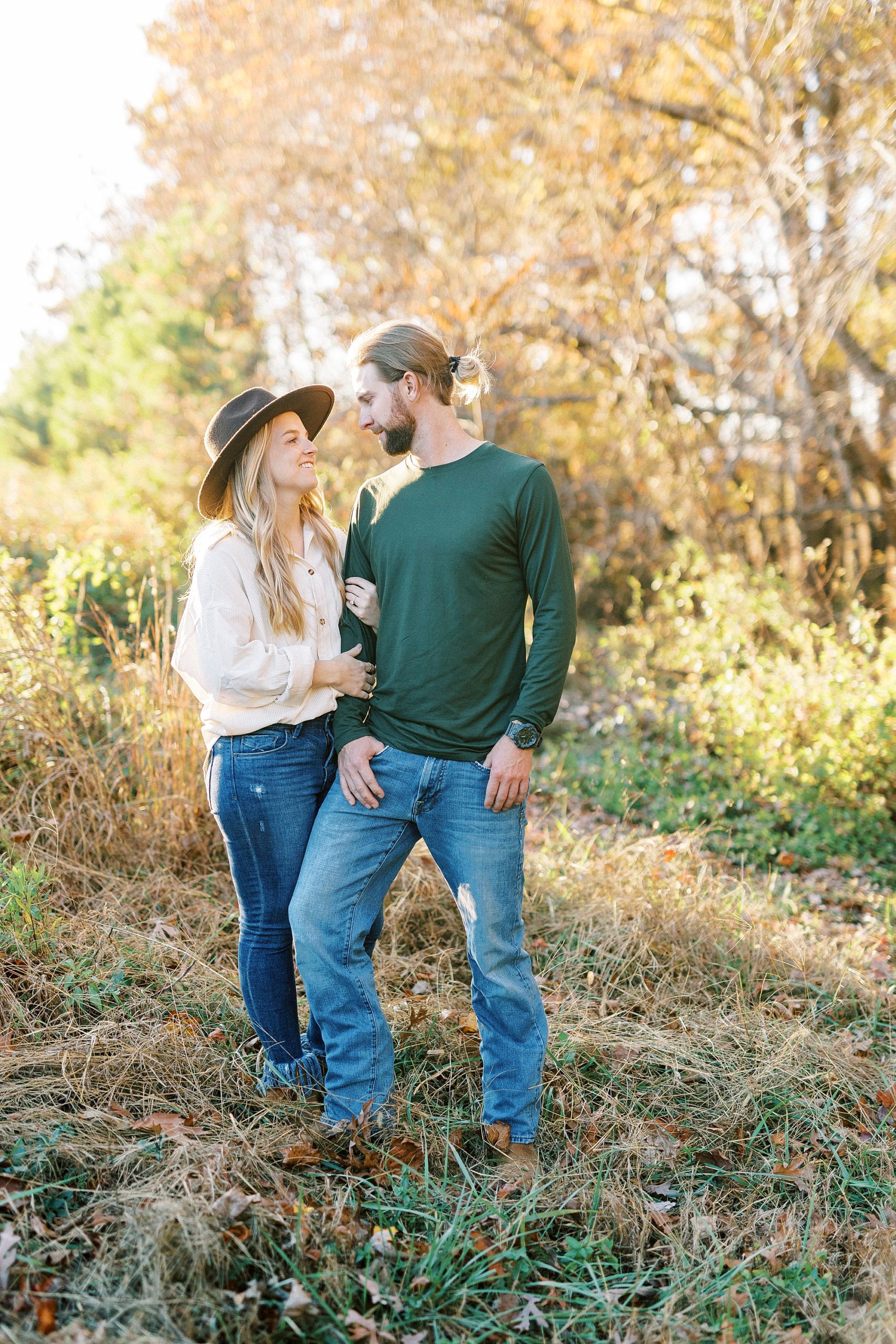 groom looks down at fiancee during fall engagement session in Richfield NC