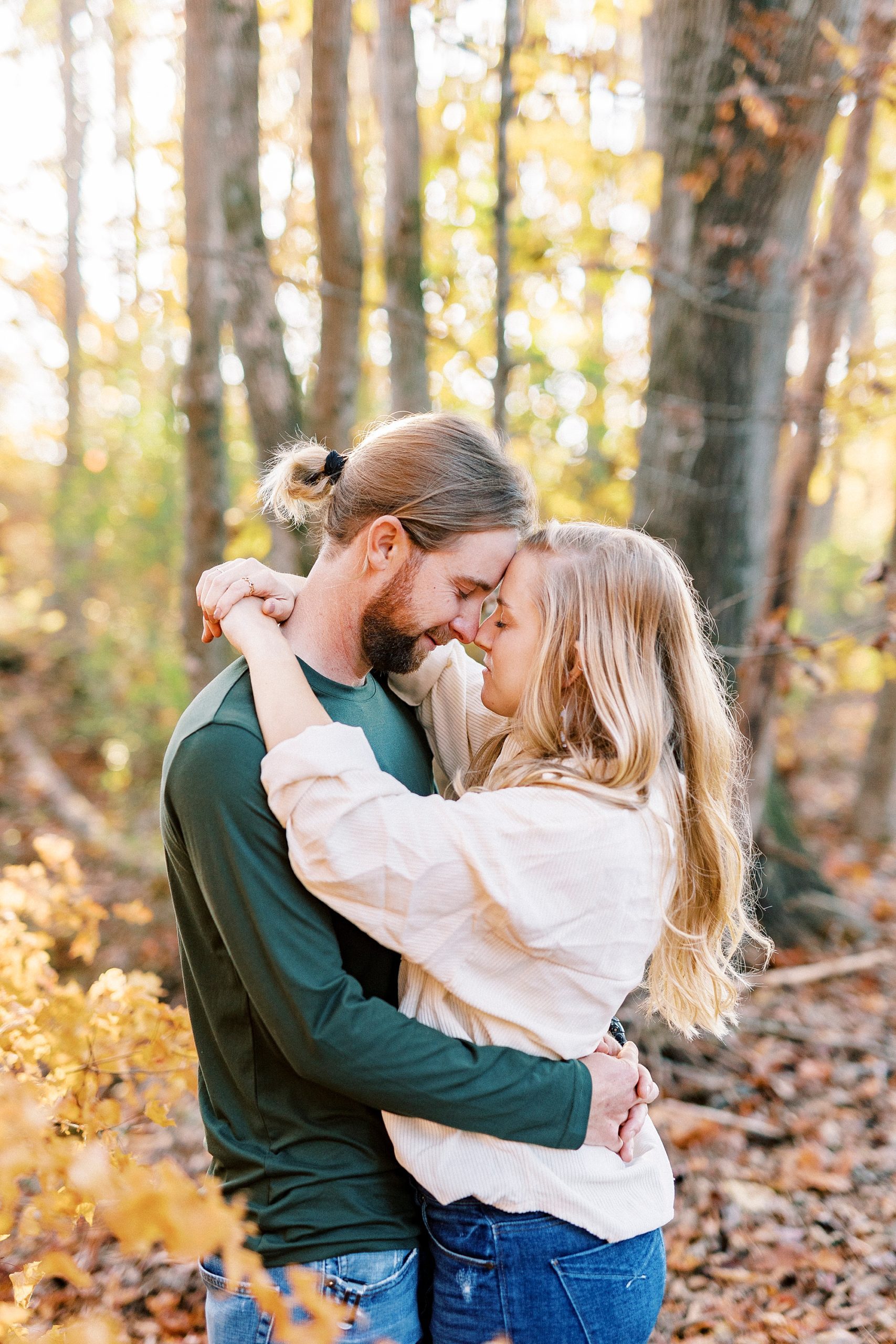 engaged couple hugs in woods near home in Richfield NC