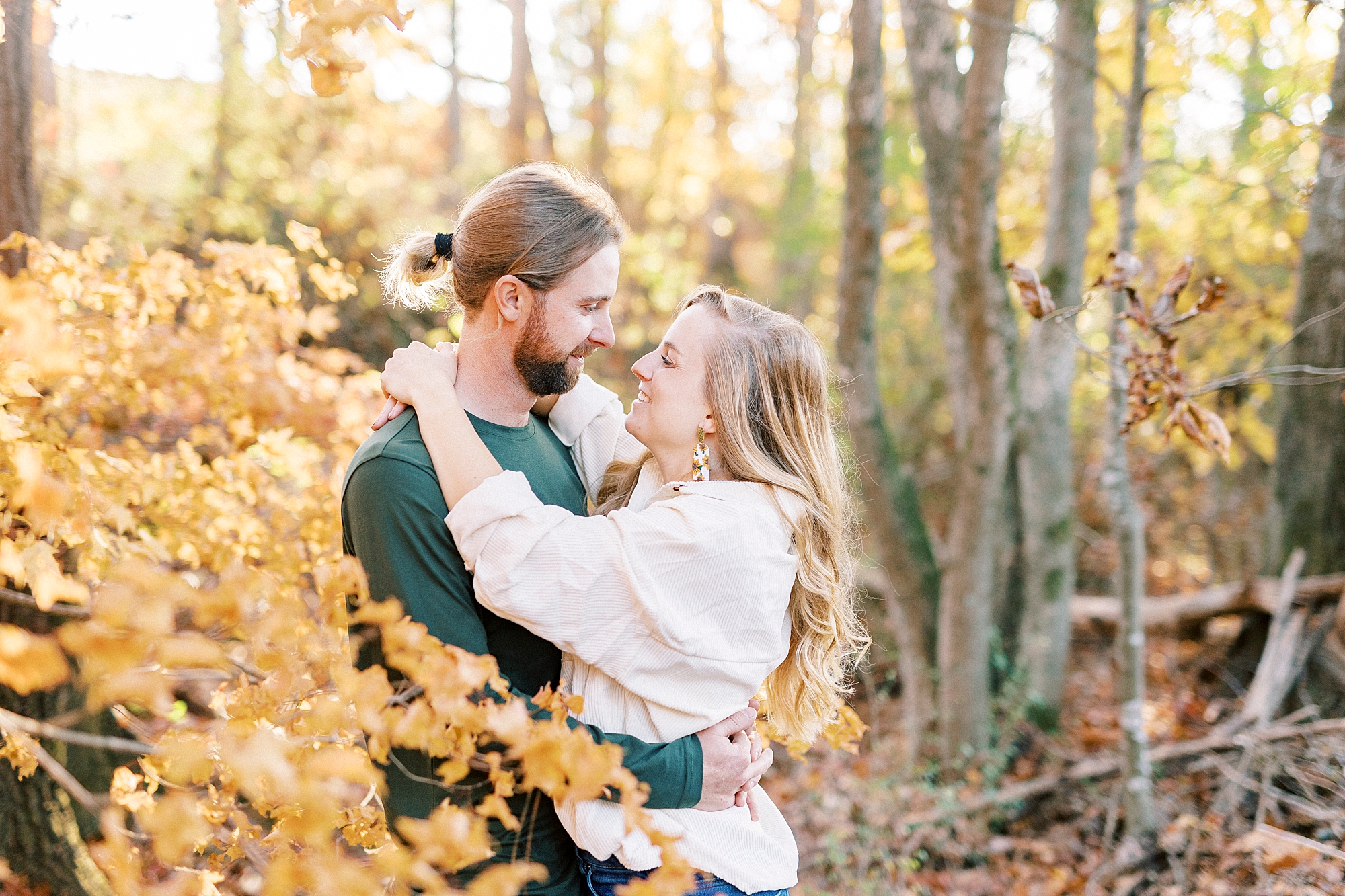 bride and groom hug together during chic fall engagement session