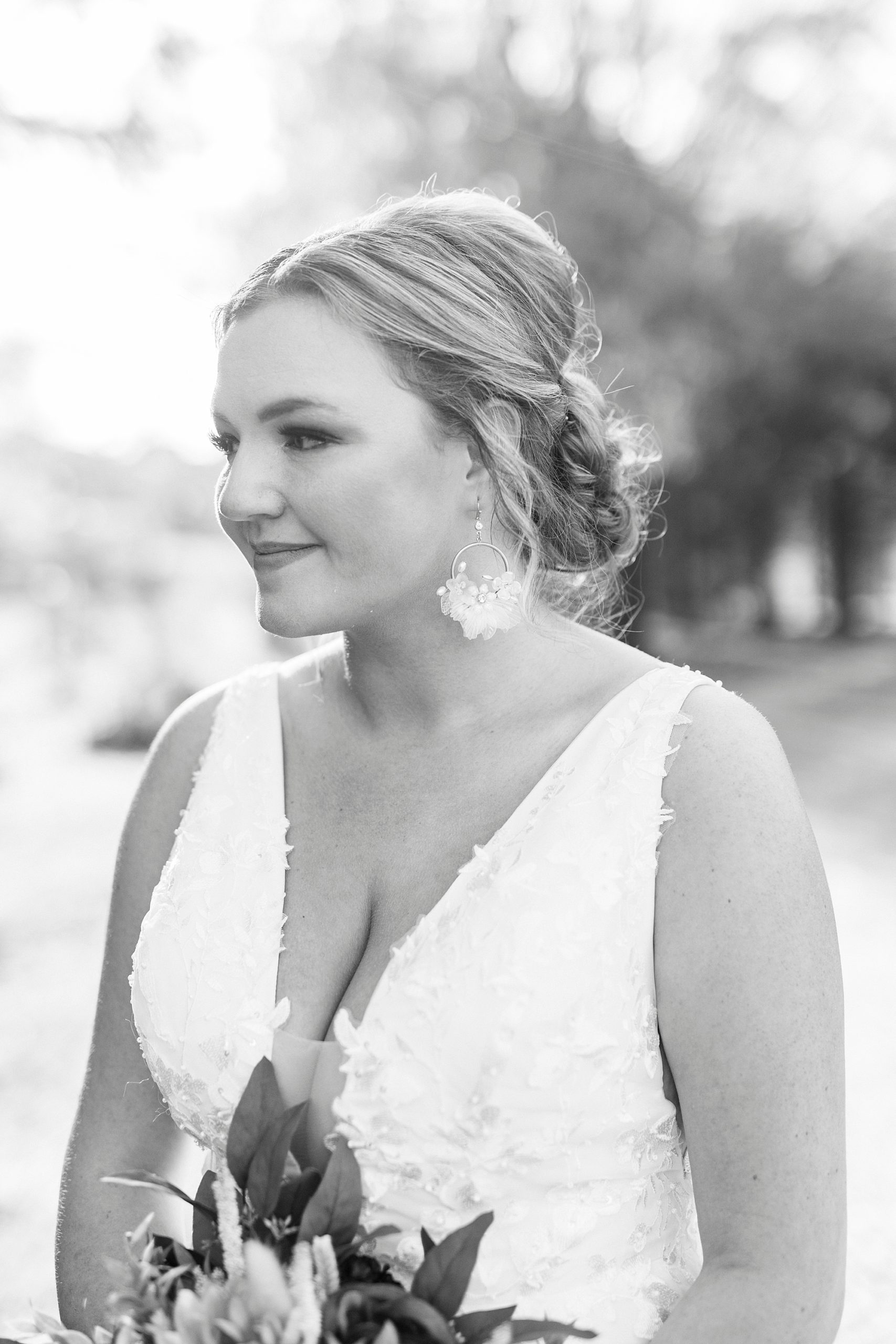 black and white portrait of bride with fun earrings 