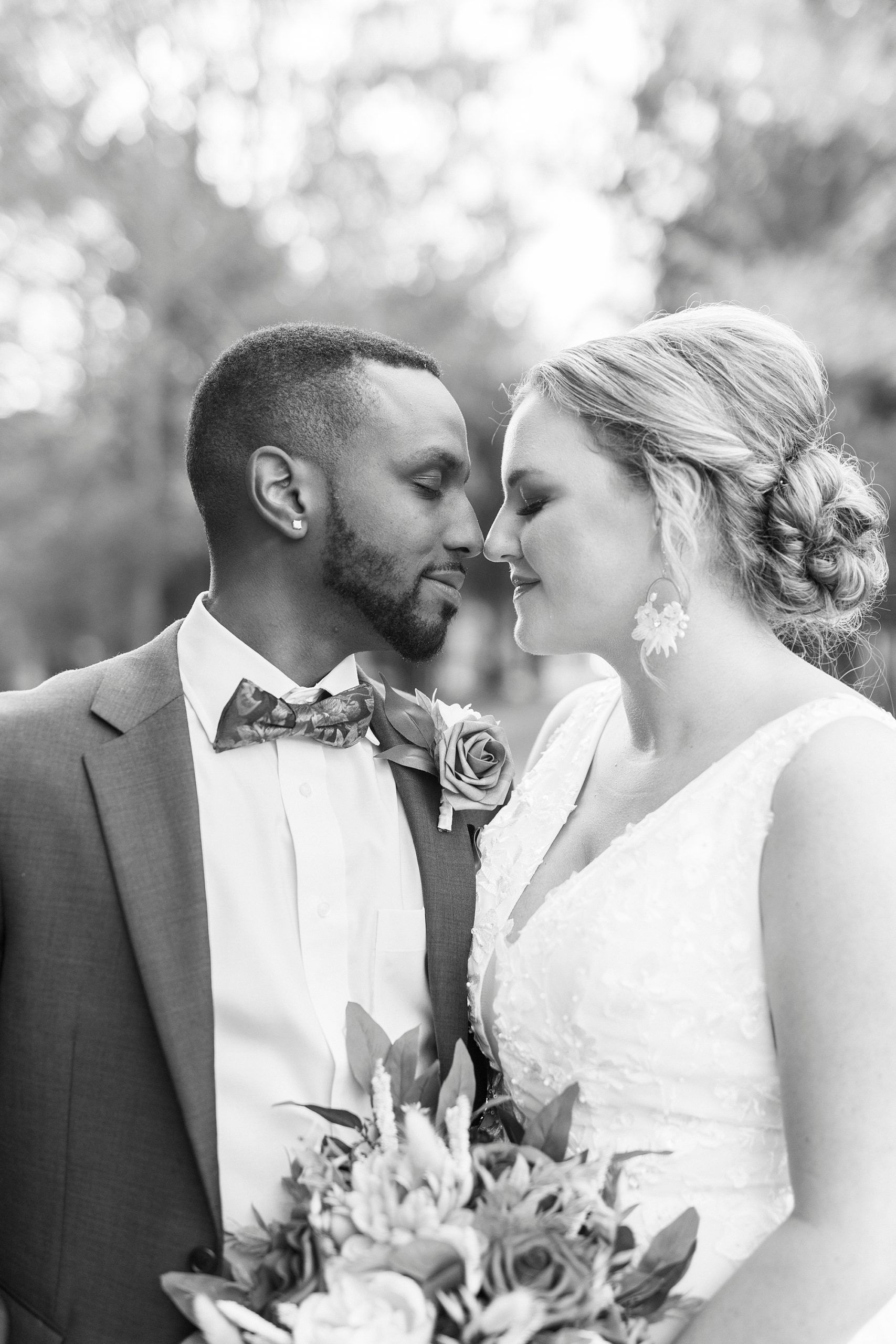bride leans to nuzzle groom's nose during fall wedding portraits 