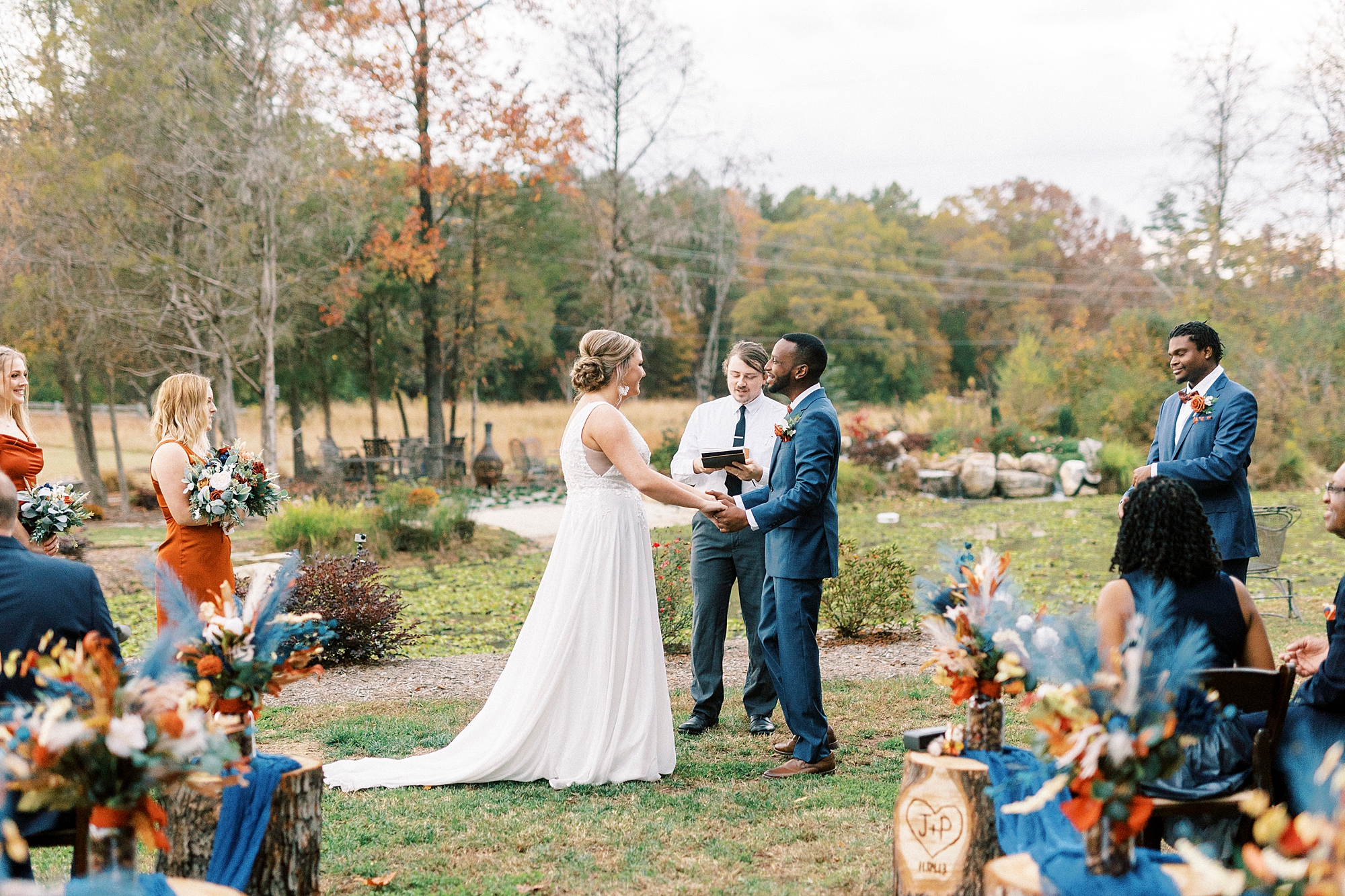 newlyweds hold hands during vows at outdoor wedding ceremony in Indian Trail, NC