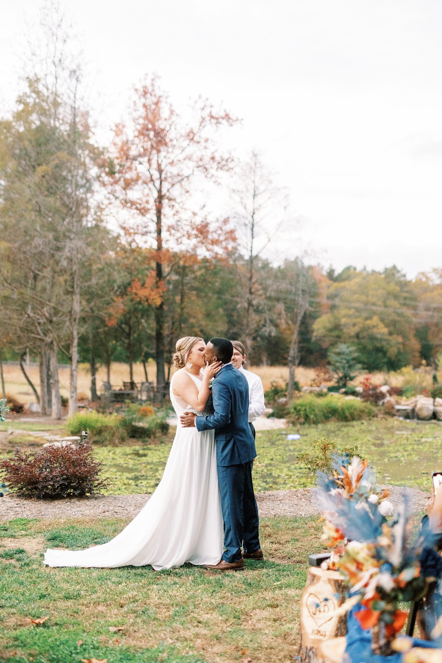 newlyweds kiss during outdoor wedding ceremony in Indian Trail, NC