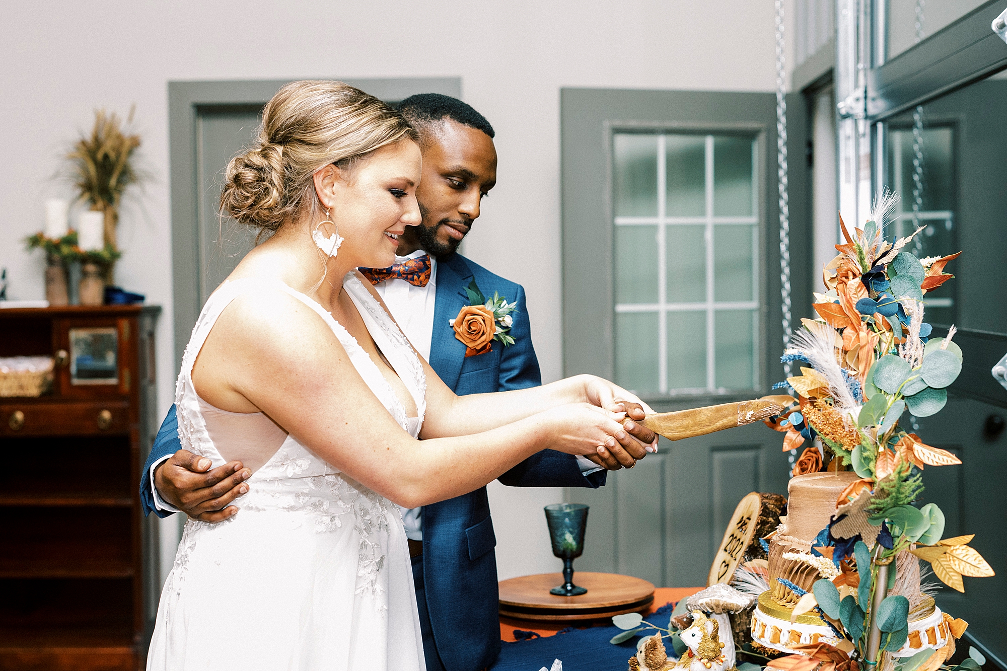bride and groom cut wedding cake during NC wedding reception 
