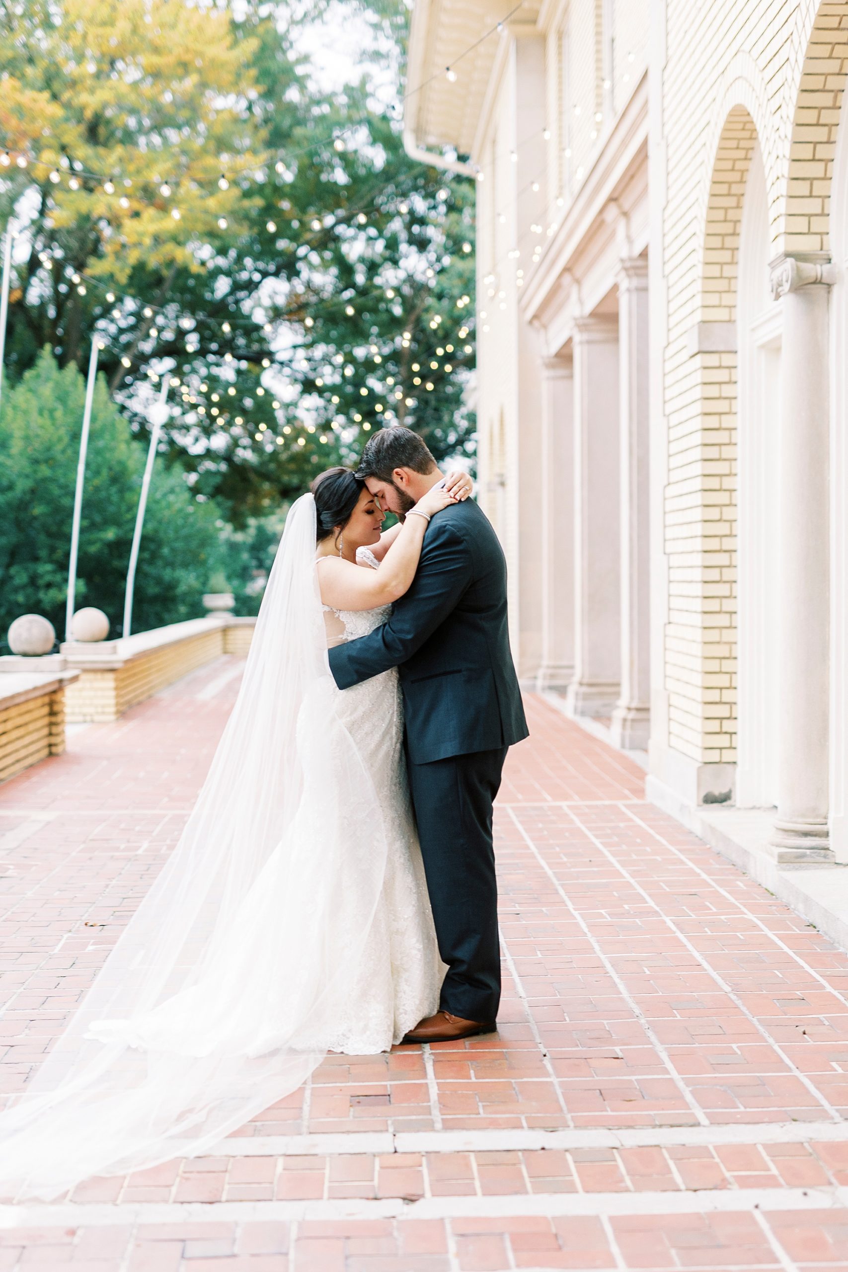 bride and groom hug on brick patio at Separk Mansion
