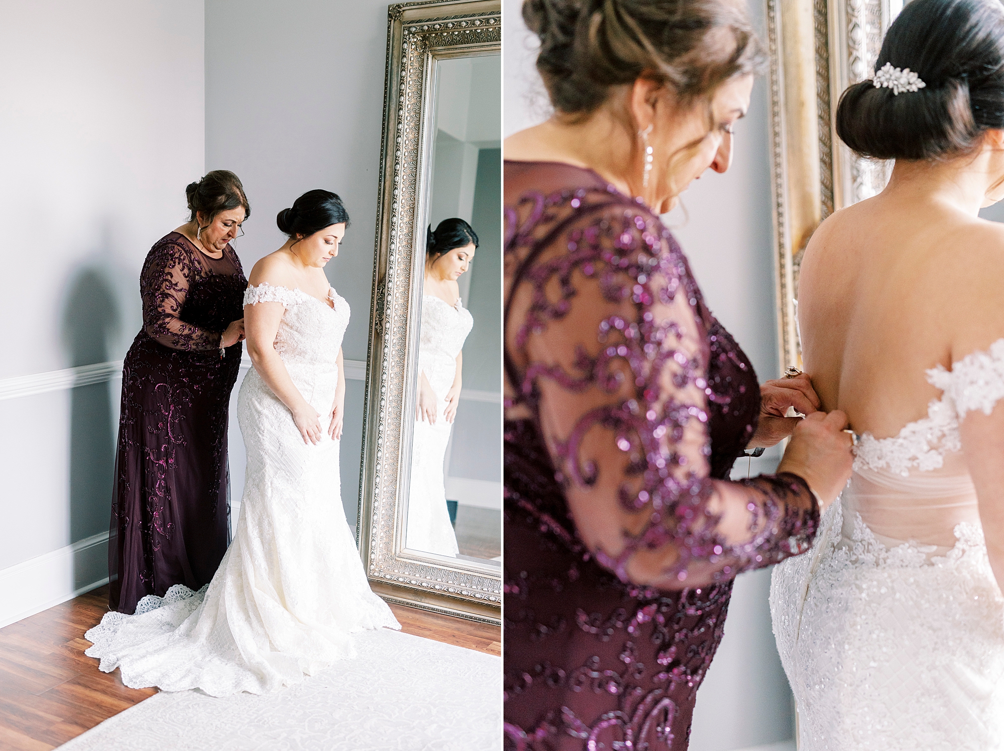 mother helps bride into wedding gown by mirror in bridal suite 