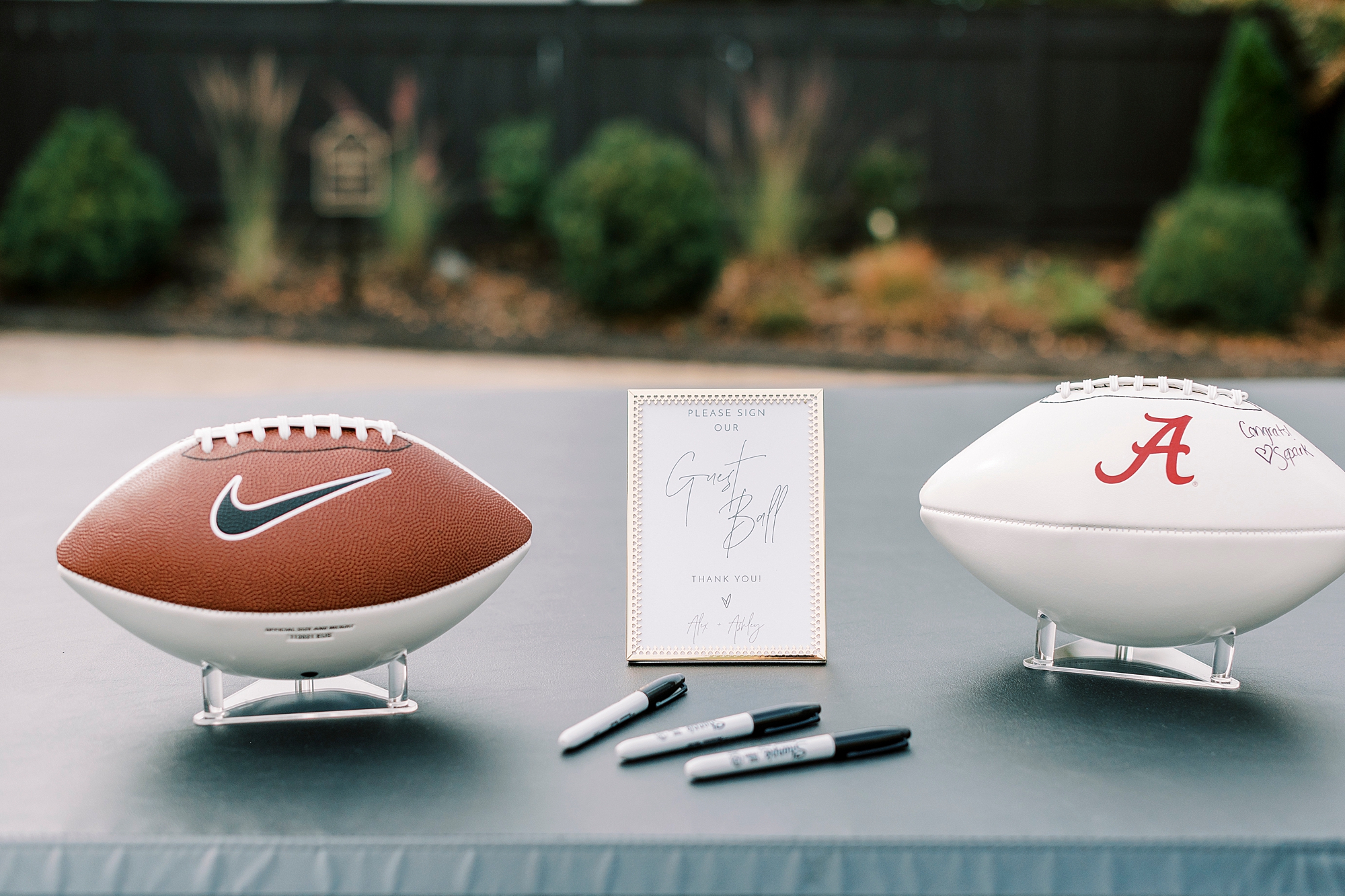 footballs for guest book rest on back of pickup truck 