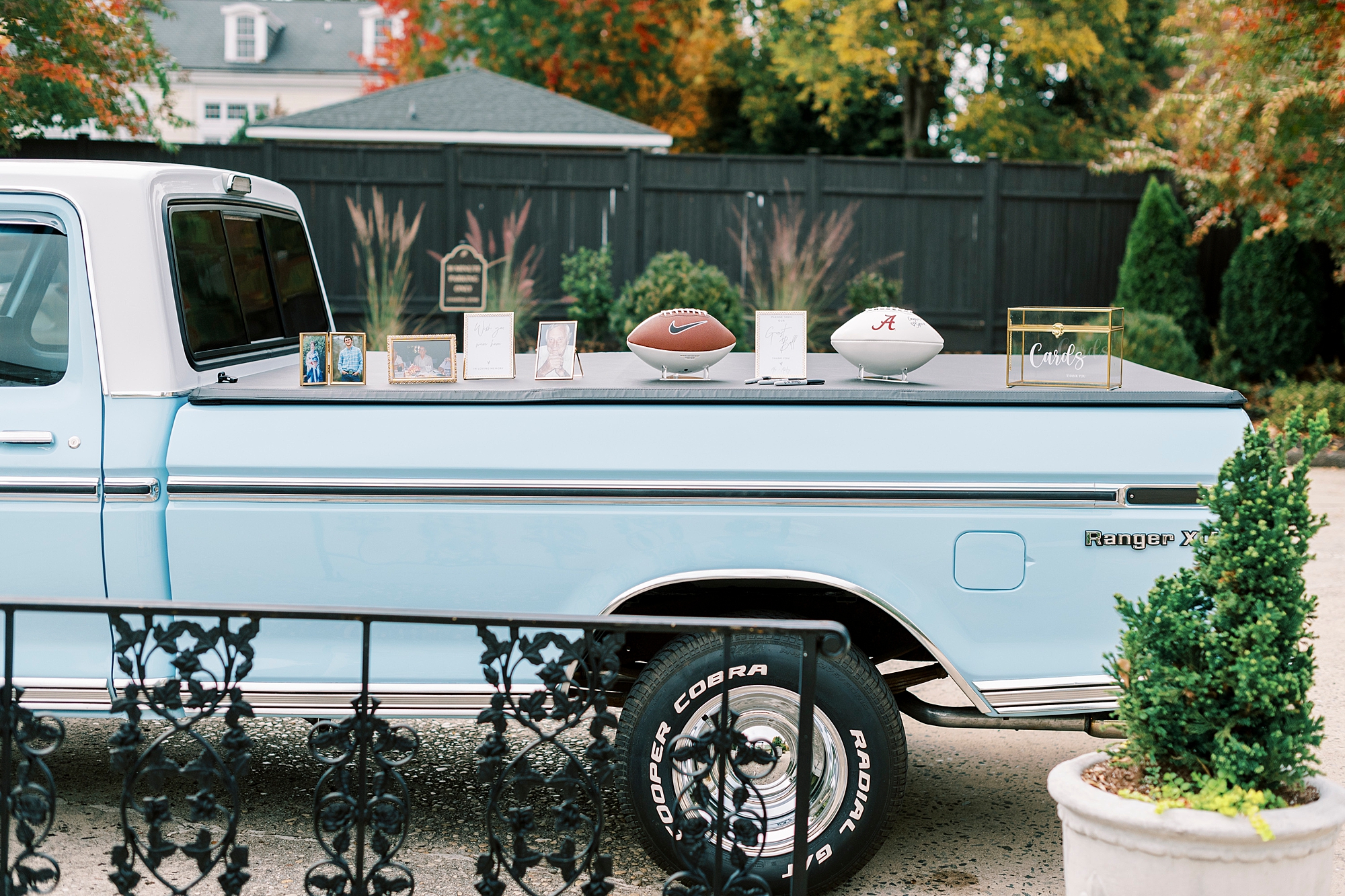 football guest books lay on back of blue pickup truck 