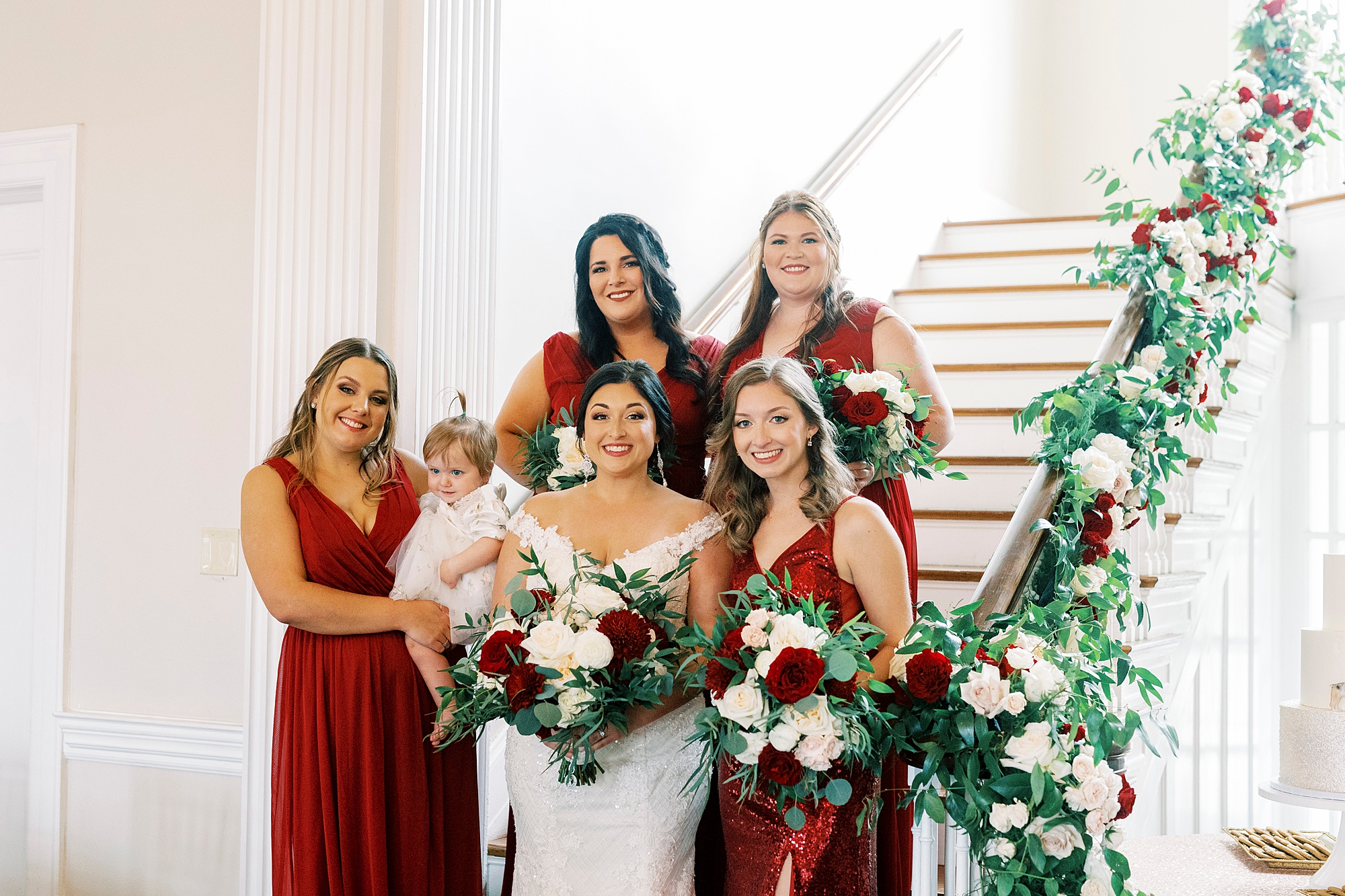 bride and bridesmaids pose on staircase inside Separk Mansion 