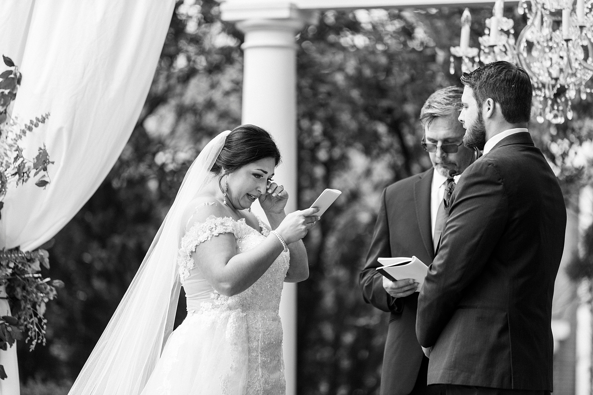 bride cries reading vows during outdoor wedding ceremony at Separk Mansion