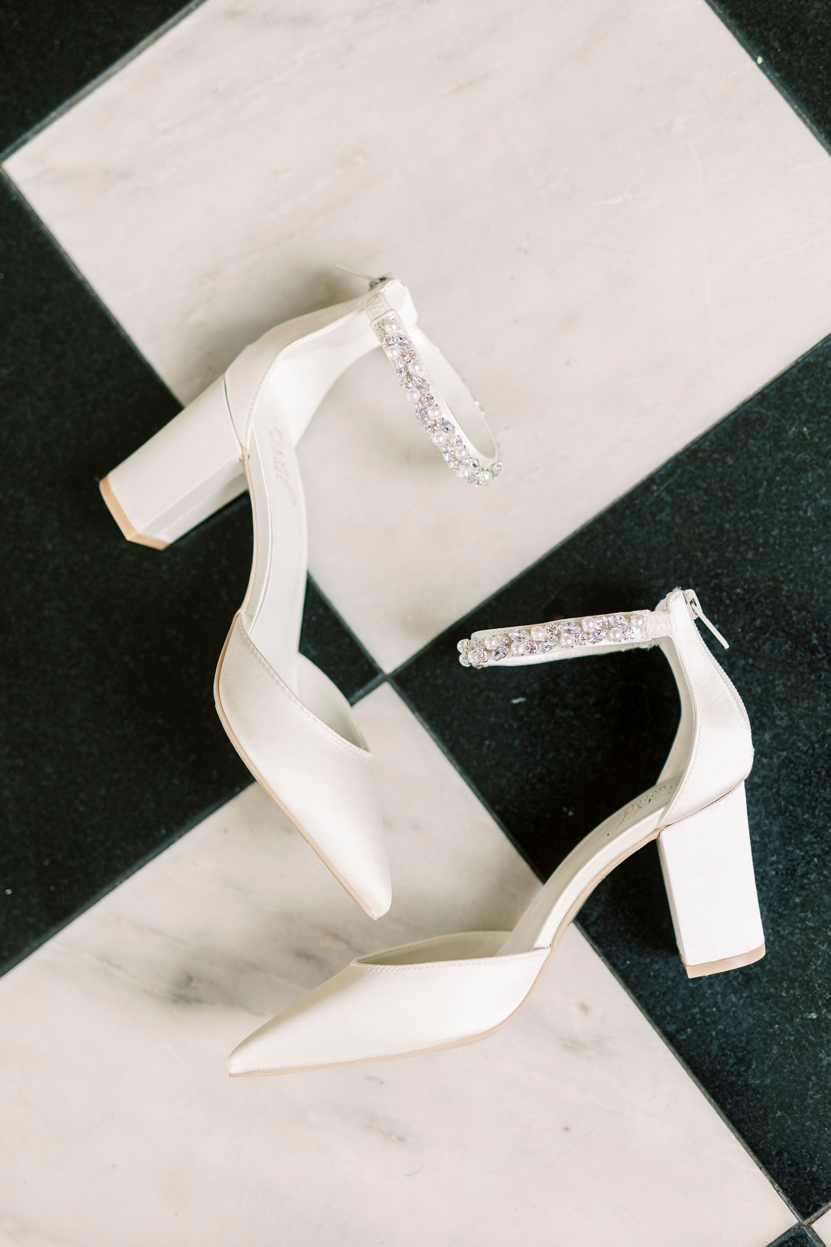 bride's ivory heels on black and white floor