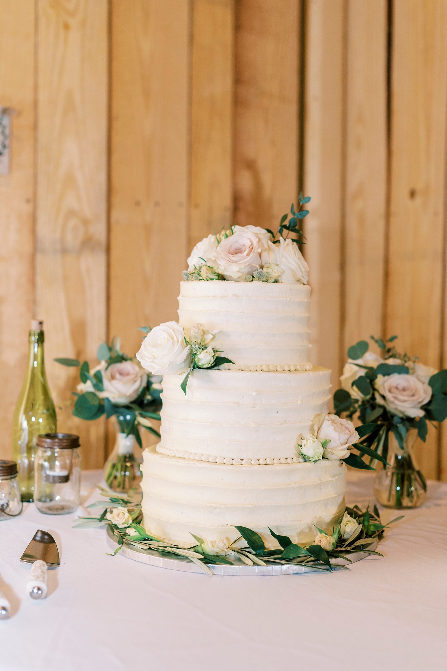 tiered wedding cake with pink floral accents 