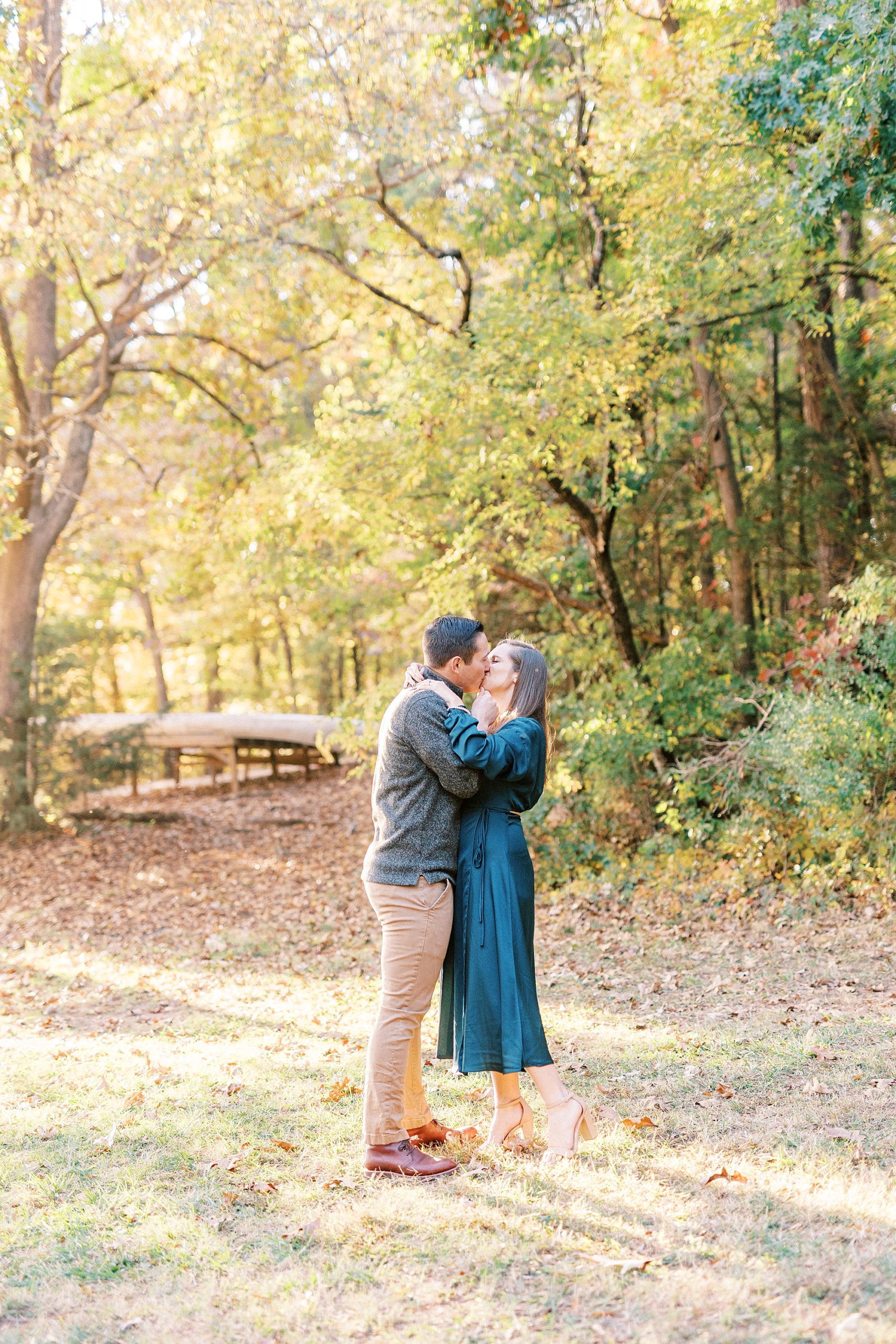 bride and groom kiss during fall engagement photos at Latta Nature Preserve