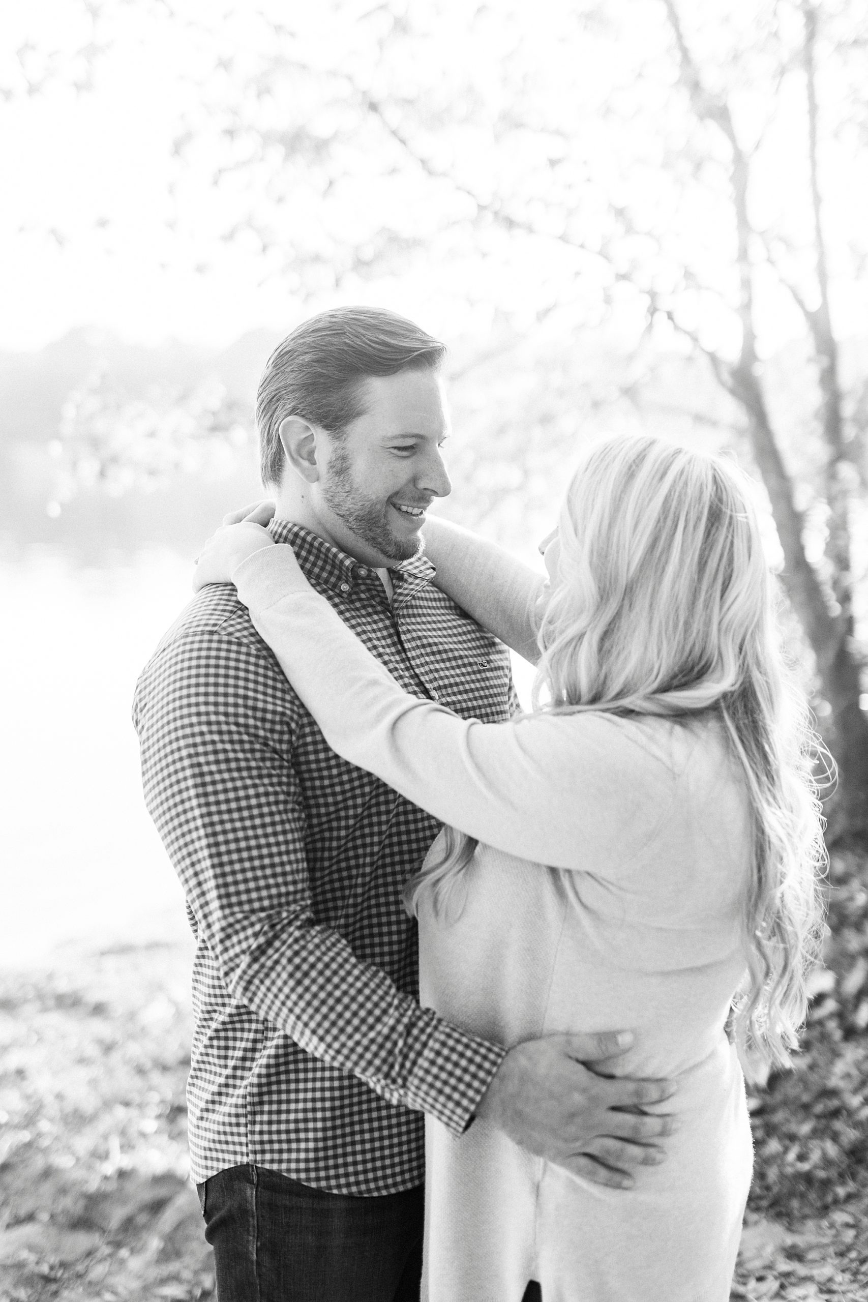 engaged couple laughs together at Latta Nature Preserve