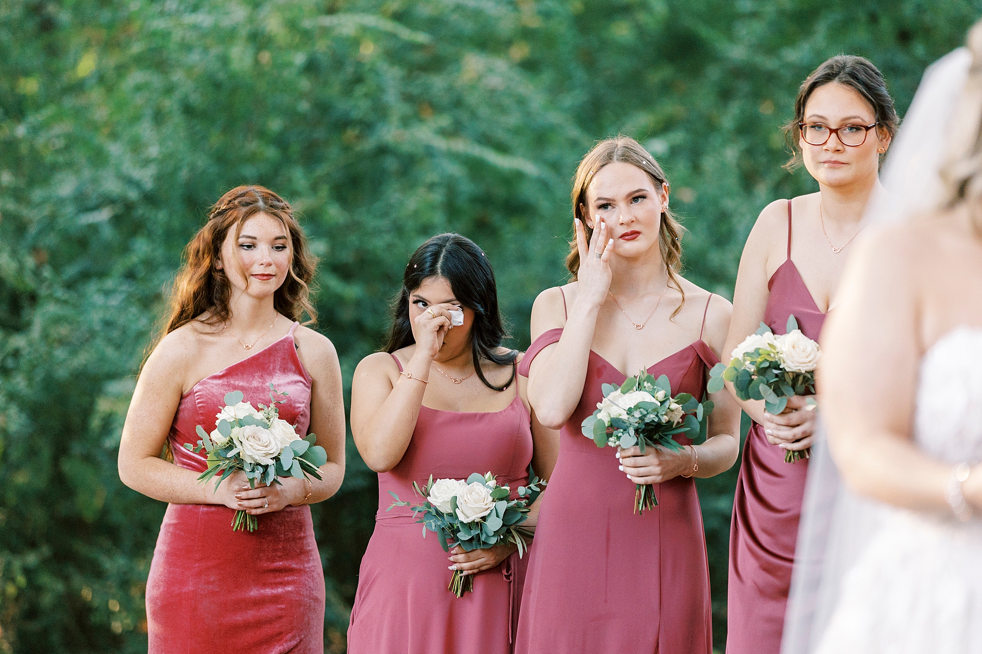 bridesmaid wipes tear away during wedding ceremony 