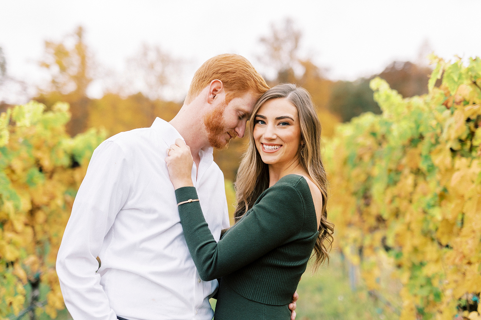 groom leans into bride during fall engagement portraits at Raffaldini Vineyards