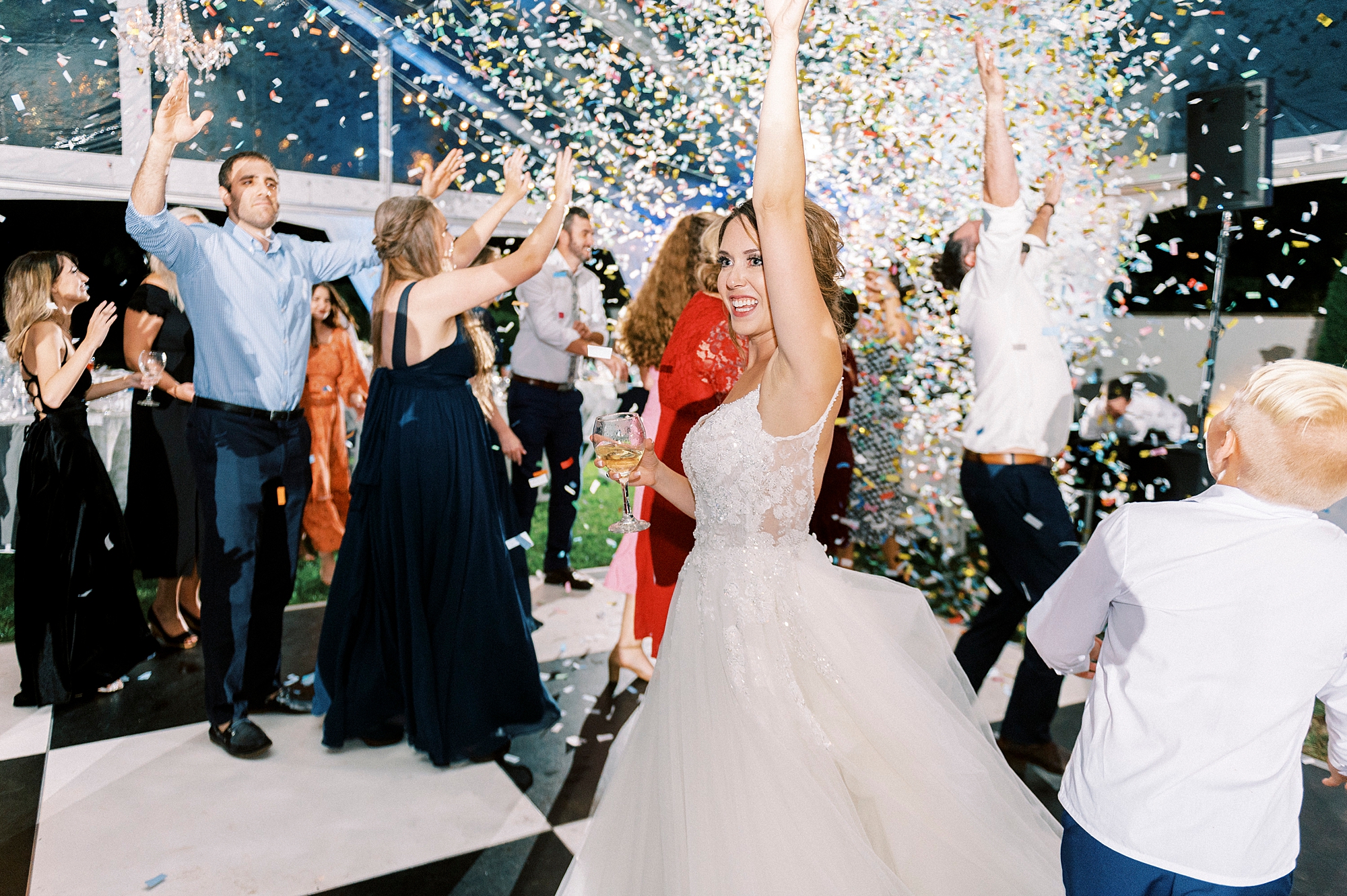 bride and groom dance on floor with confetti popping