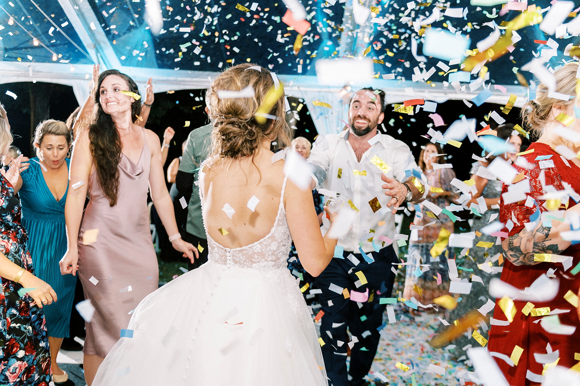 bride and groom dance during reception with confetti around them