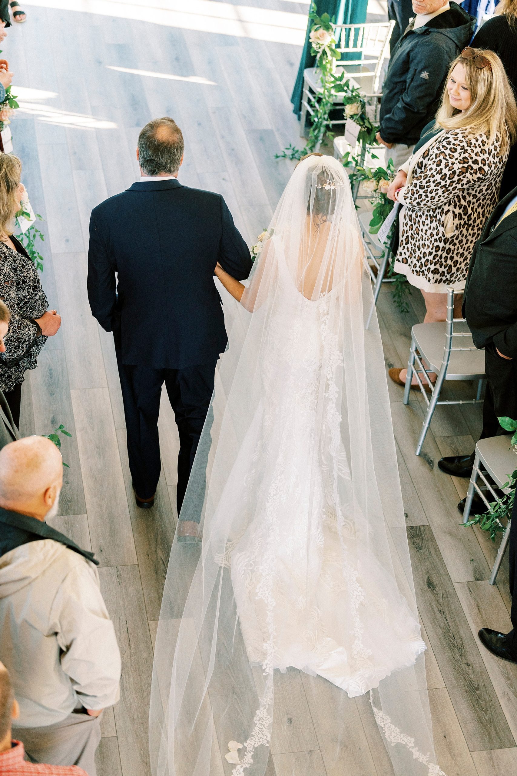bride walks down aisle with father at Chickadee Hill Farms