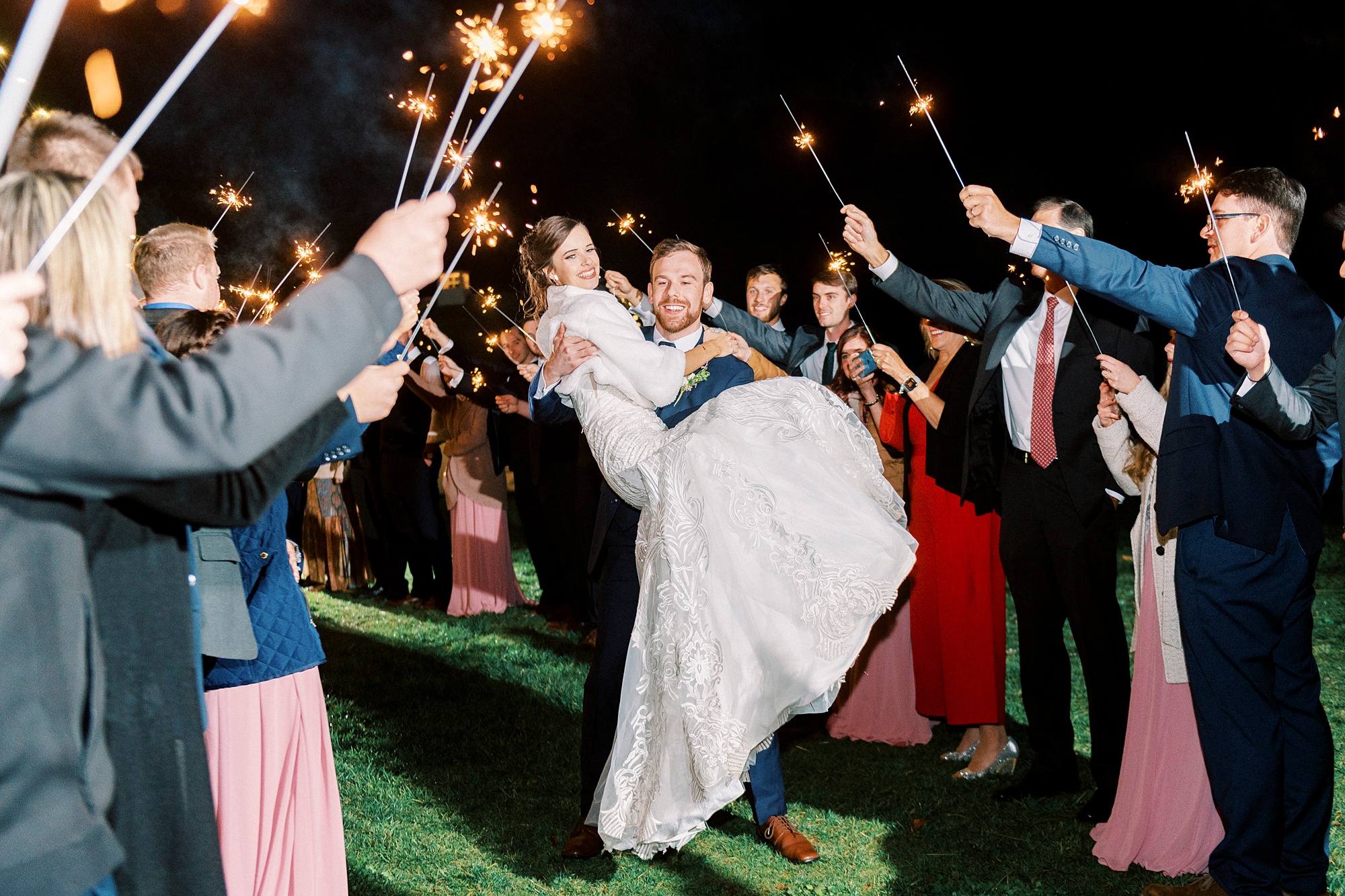 groom carries bride through sparkler exit in North Carolina 
