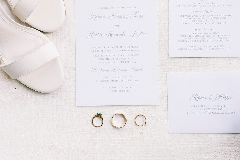 invitation suite, bride's white shoes and wedding rings 