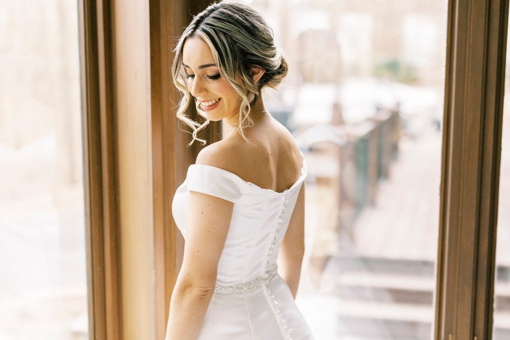 bride looks over shoulder in classic wedding gown 