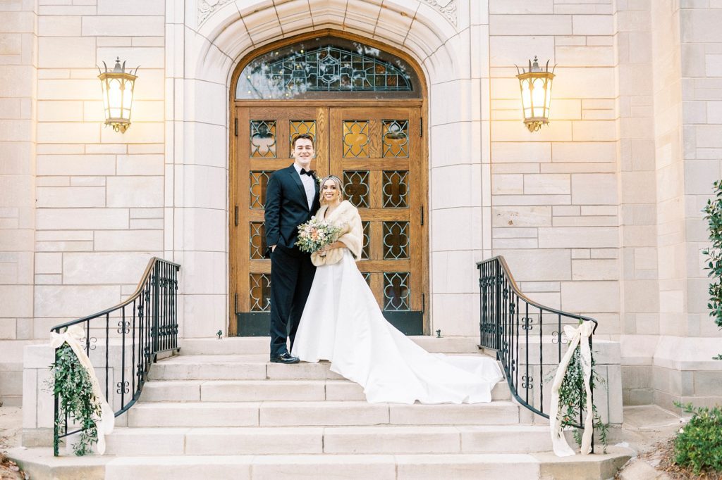 bride and groom stand on steps of St. James Lutheran Church in Concord NC