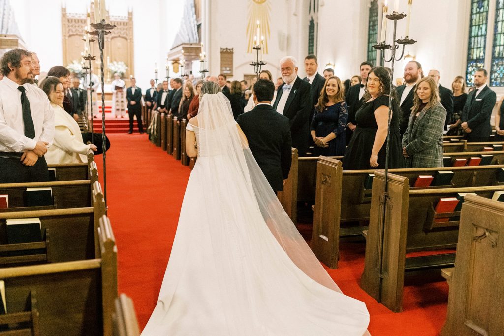 bride walks into ceremony at St. James Lutheran Church in Concord NC