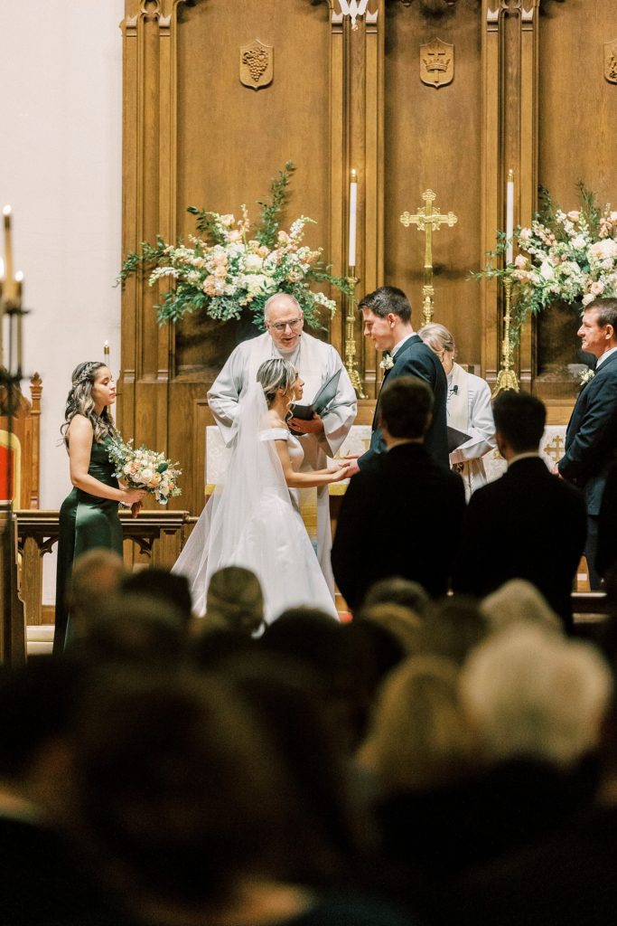 bride and groom kiss during ceremony at St. James Lutheran Church in Concord NC