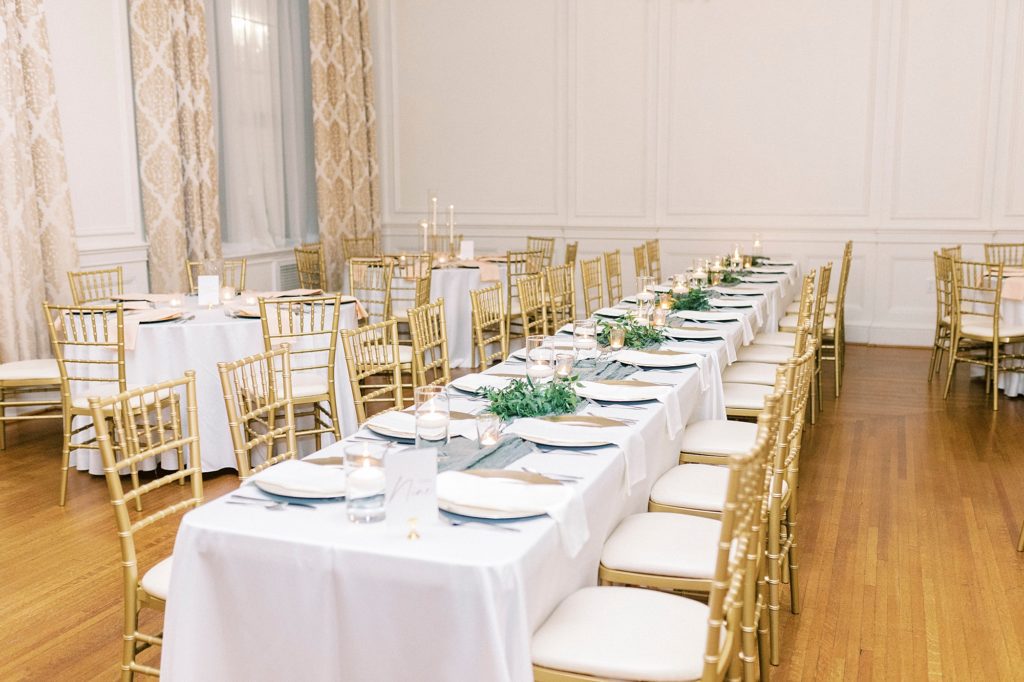 family style seating with greenery on white tablecloth at the Hotel Concord